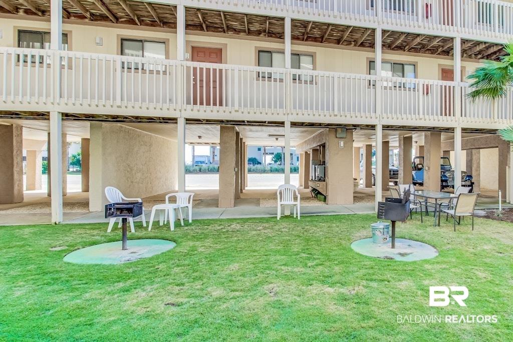 Image 3: Ground-level outdoor space featuring a grass lawn