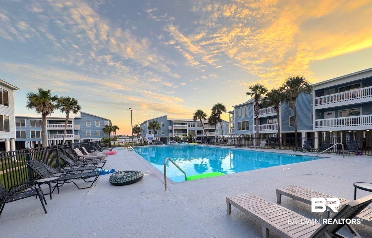 Image 2: Large outdoor swimming pool surrounded by a concrete deck