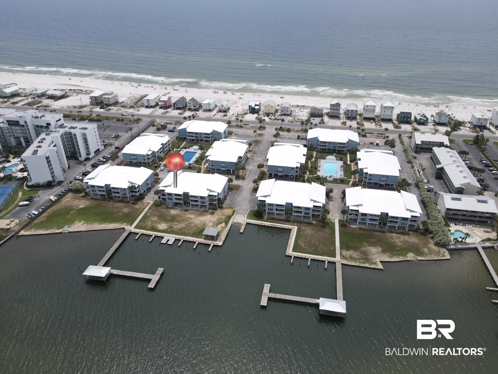 Image 3: Waterfront community featuring multiple buildings, private docks, and a swimming pool