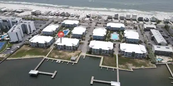 Image 3: Waterfront community featuring multiple buildings, private docks, and a swimming pool