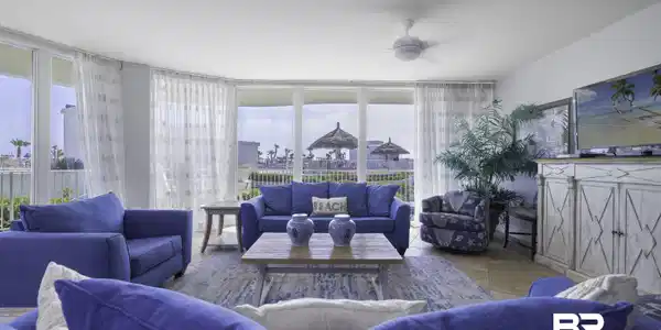 Image 3: Living area with ceiling fan and expansive windows