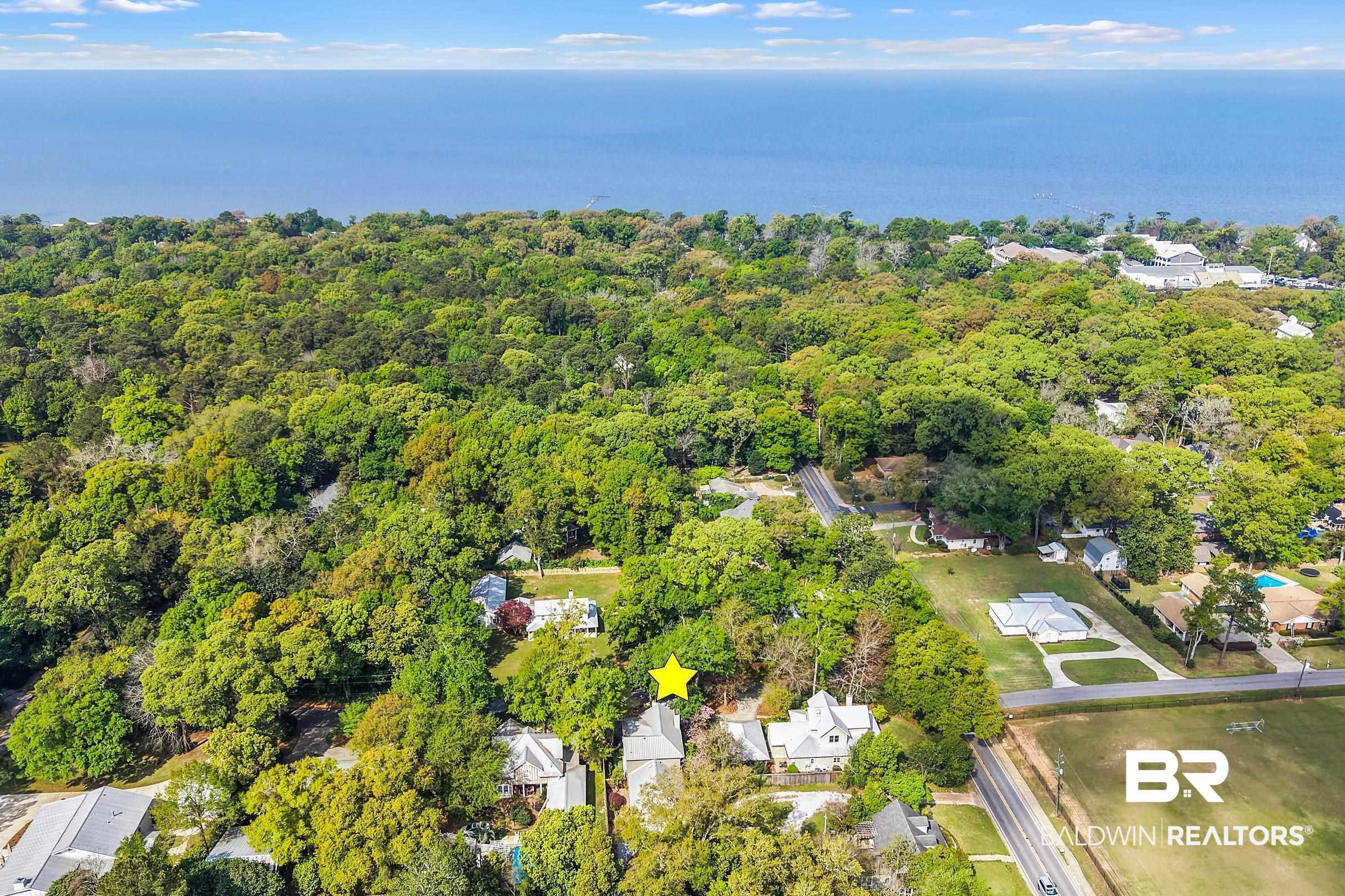 Image 3: Aerial view of residential area featuring a large body of water