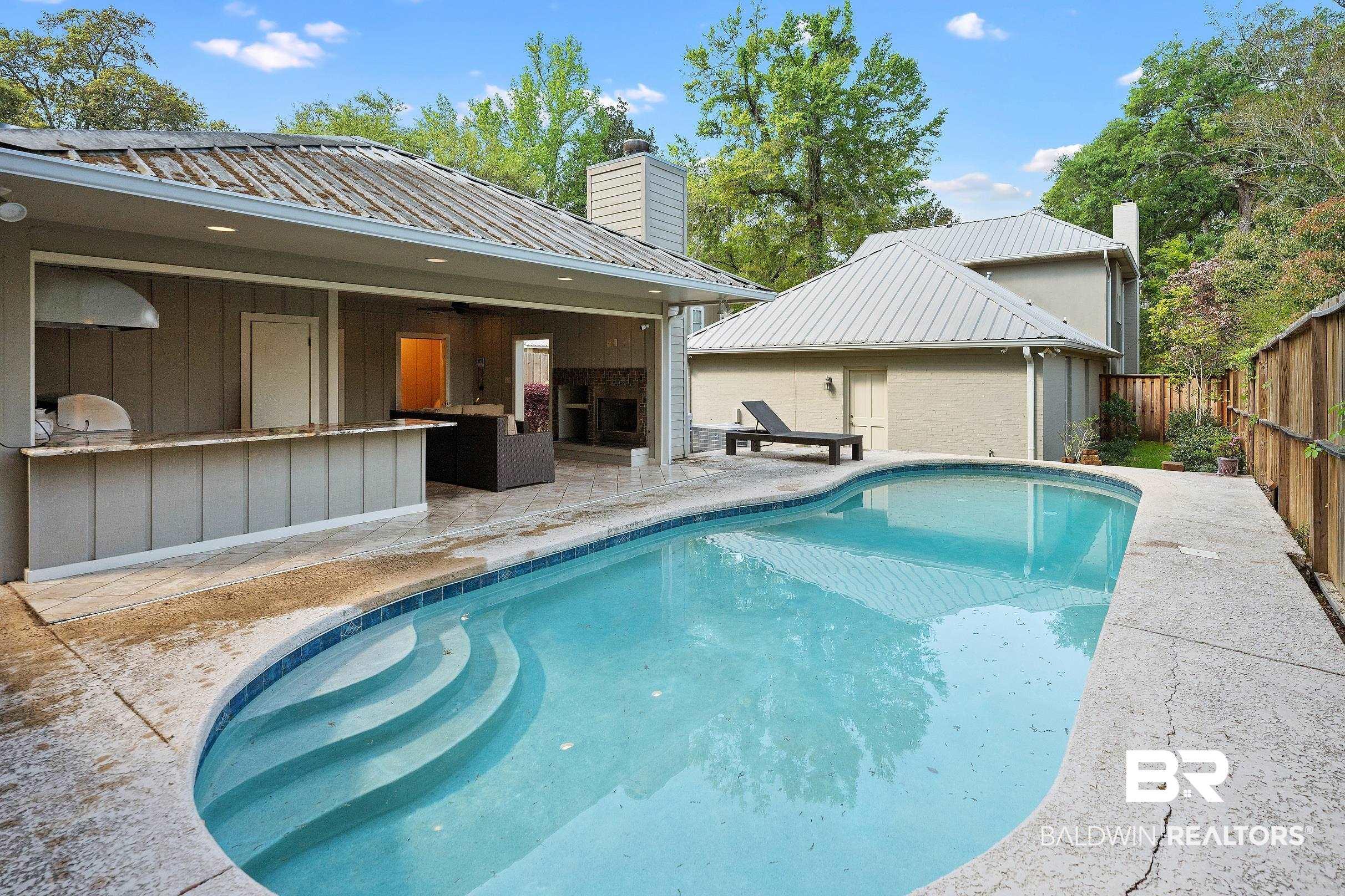 Image 4: View of swimming pool with patio surround and area for grilling
