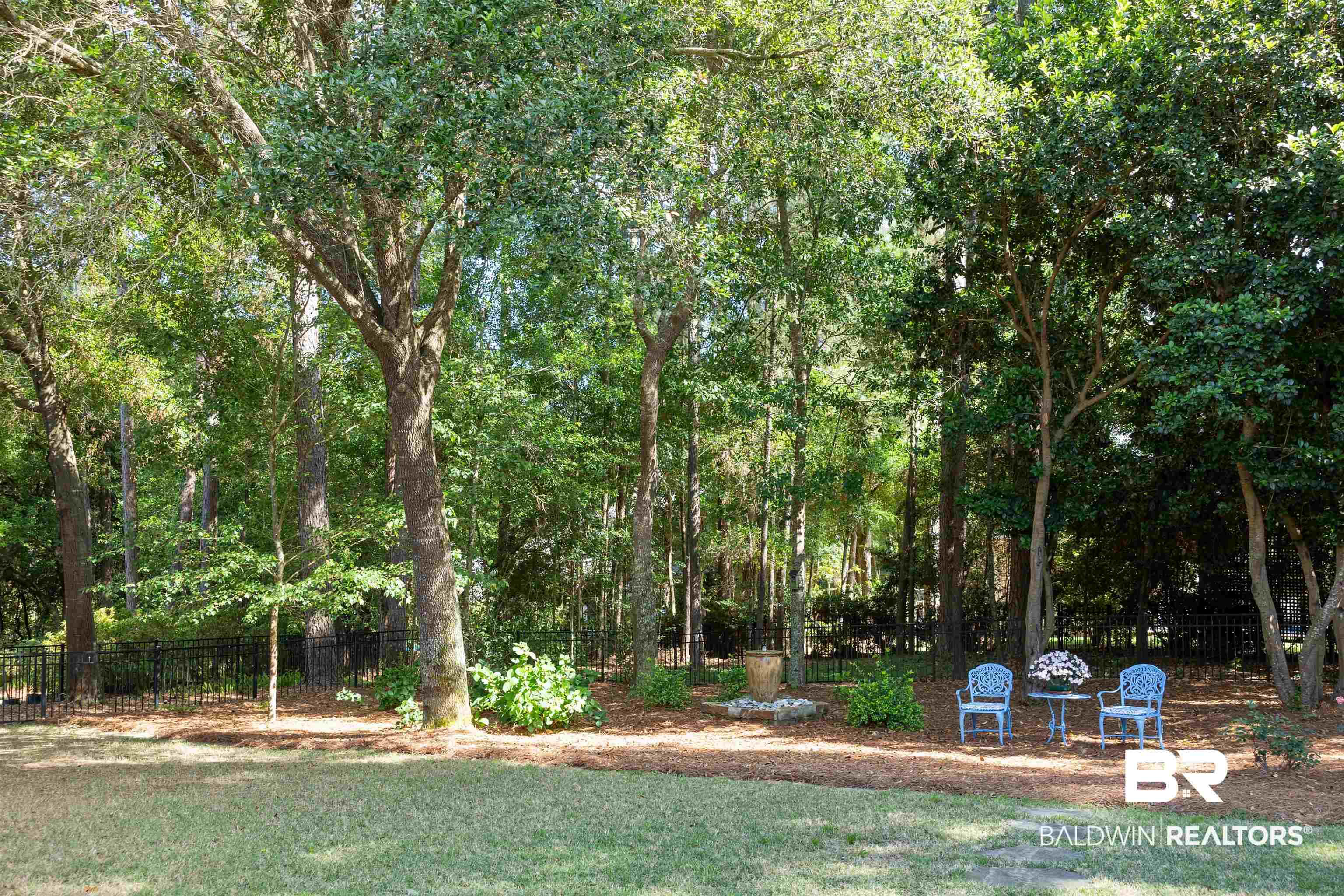 Image 3: Back yard with mature trees, fenced, private.