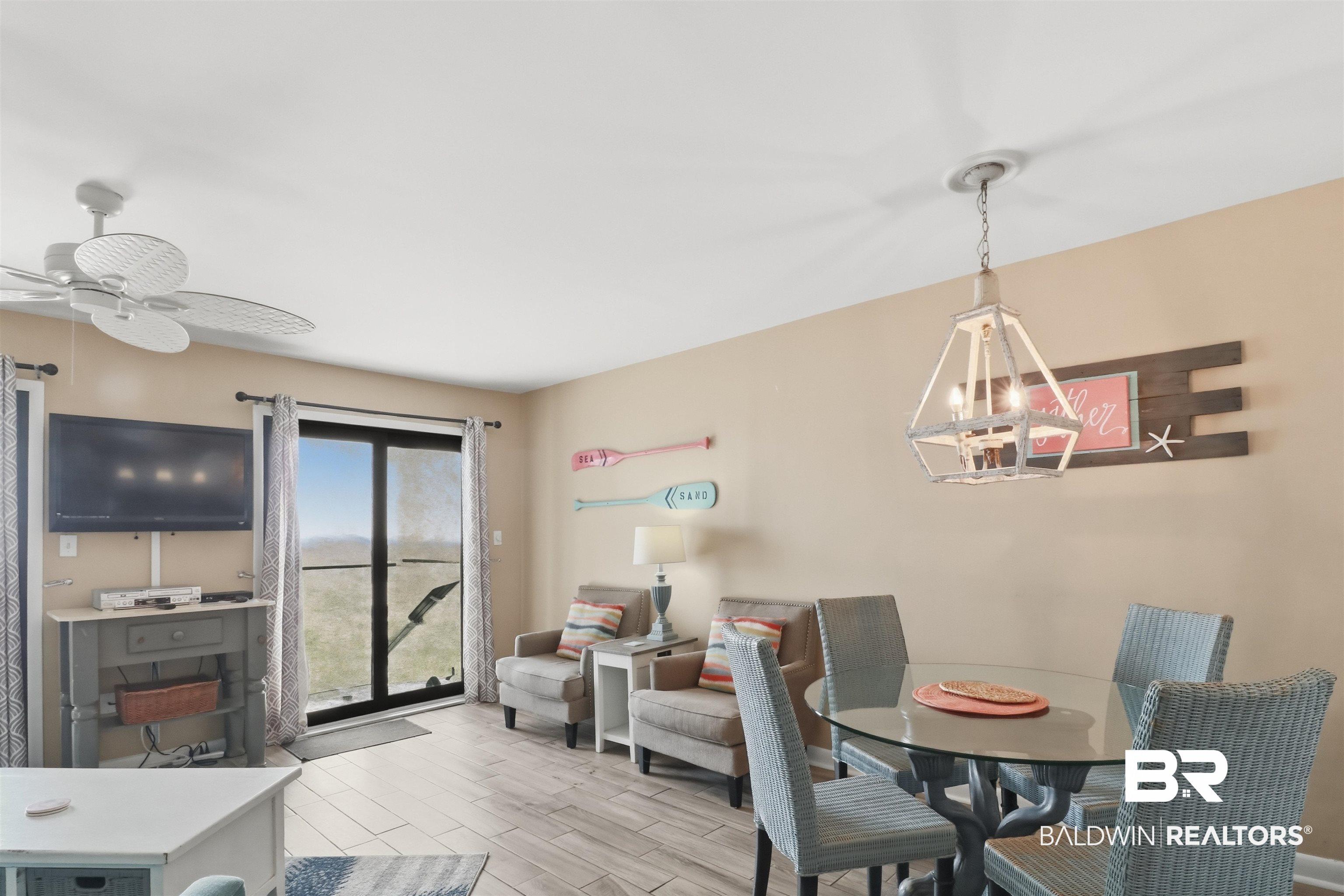 Image 4: Dining room with ceiling fan, a chandelier, and wood finish floors