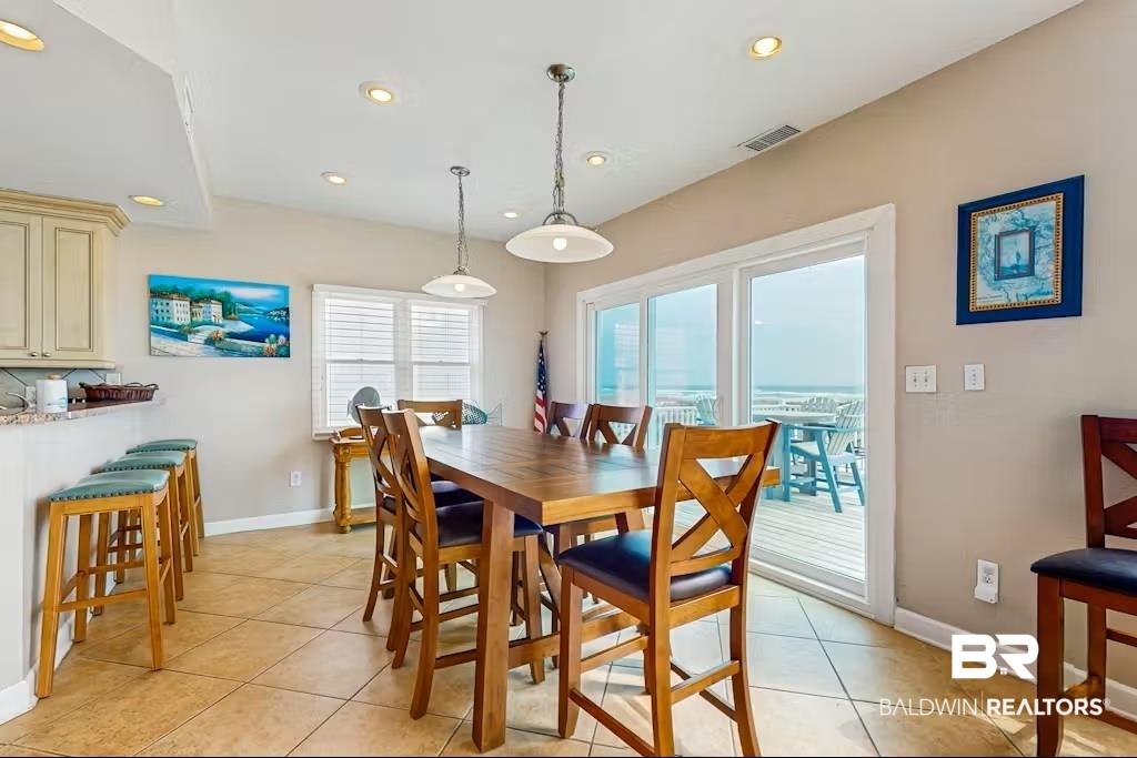 Image 3: Dining space with recessed lighting and light tile patterned floors