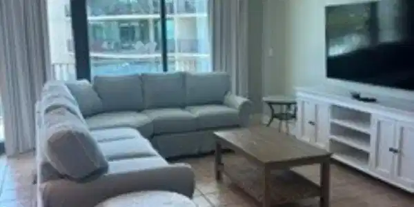 Image 2: Living area with large format tile flooring and a ceiling fan