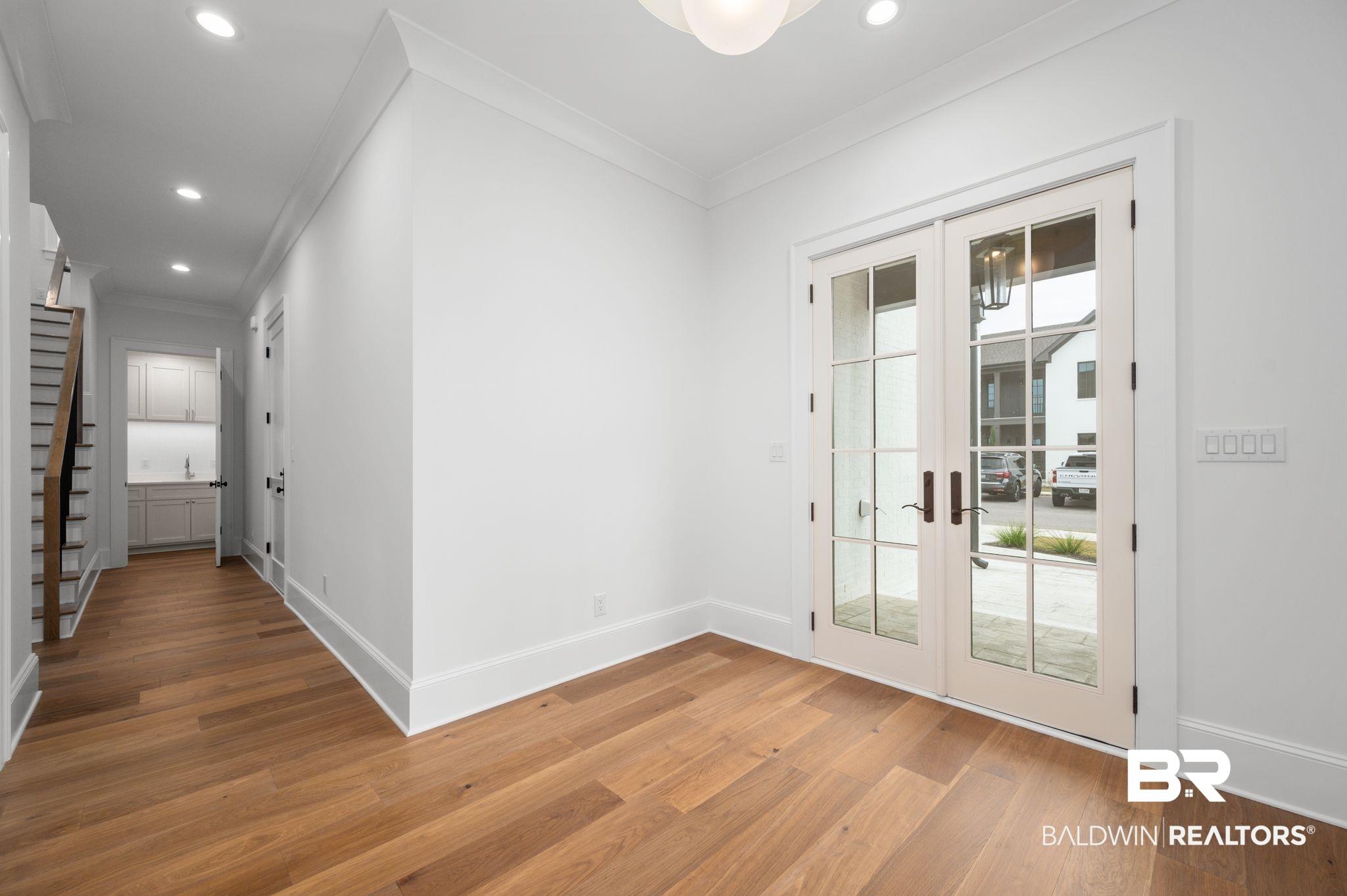 Image 2: Entryway with ornamental molding, french doors, stairs, hardwood / wood-style floors, and recessed lighting