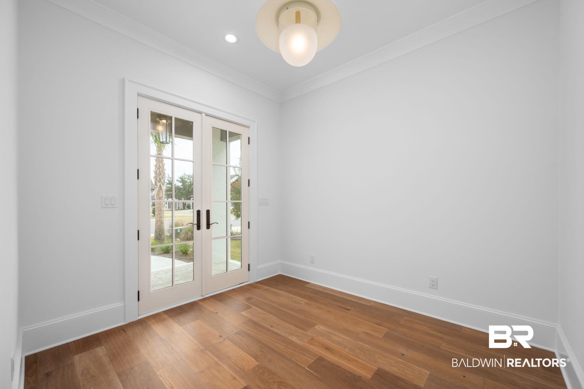 Image 3: Unfurnished room with french doors, crown molding, and wood finished floors