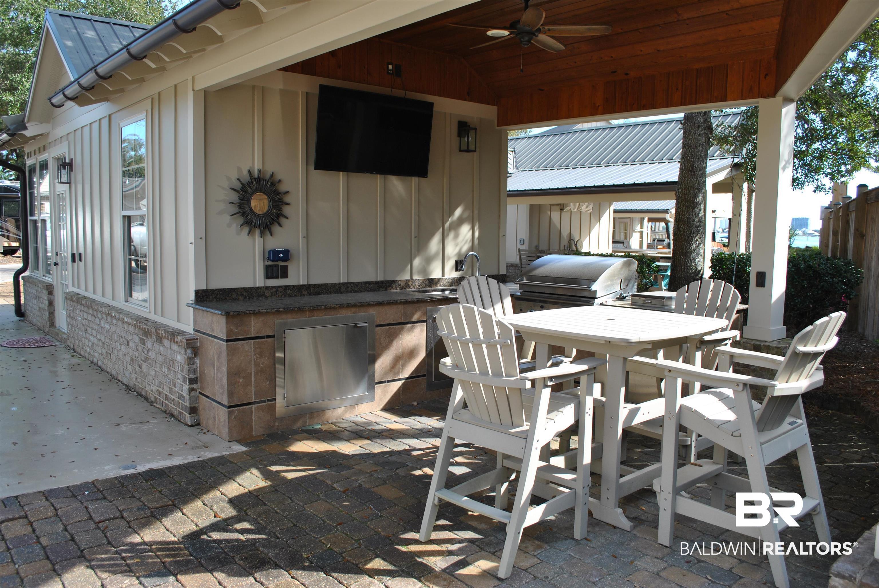 Image 4: View of patio / terrace featuring area for grilling and ceiling fan