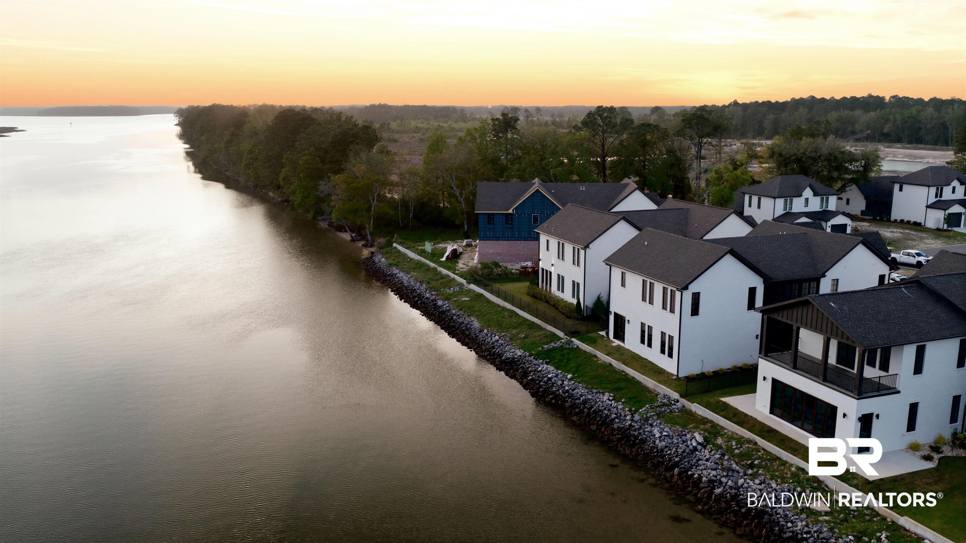 Image 2: Waterfront homes featuring contemporary architecture with dark roofs and white siding