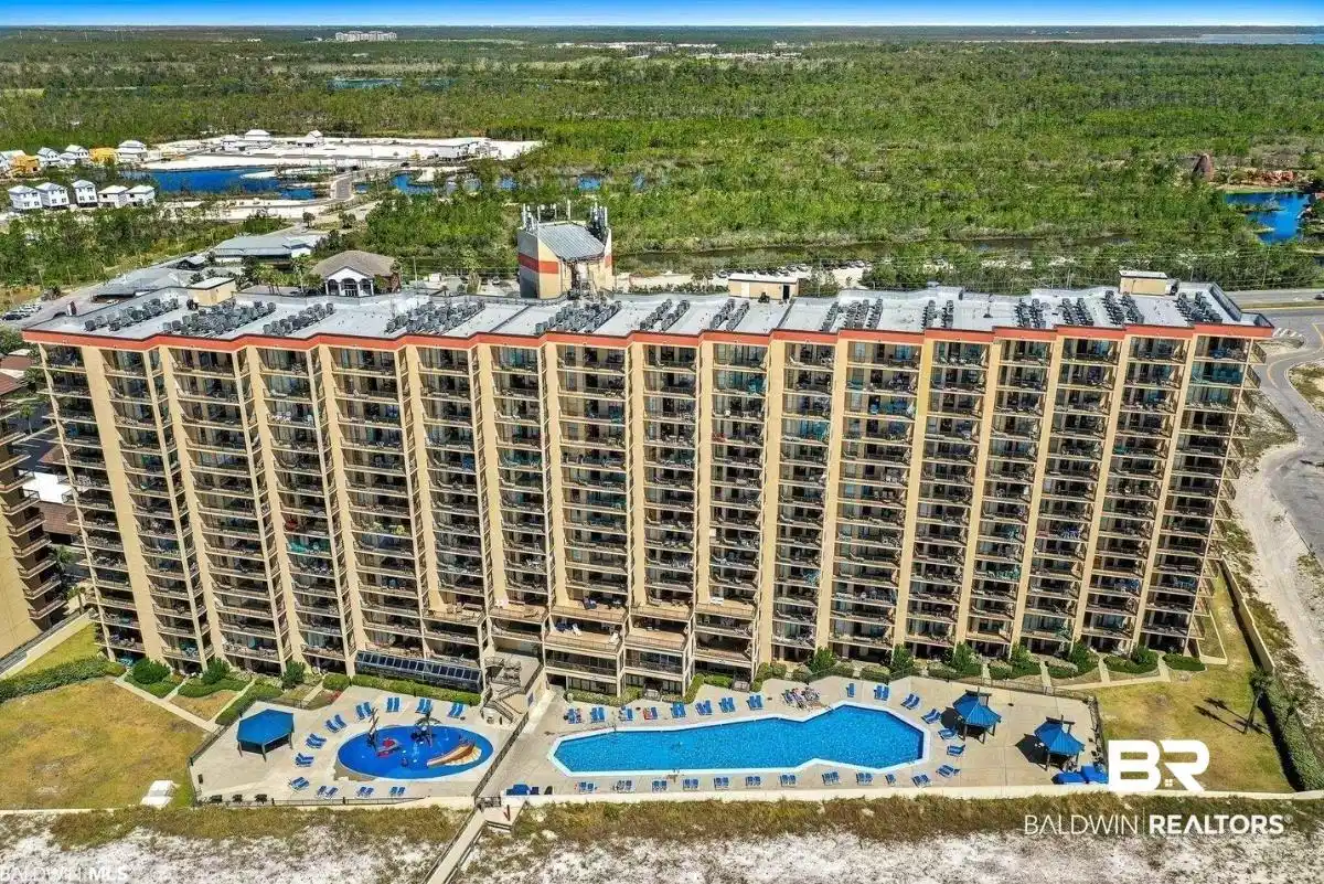 Image 1: Bird's eye view of a pool area and apartment complex