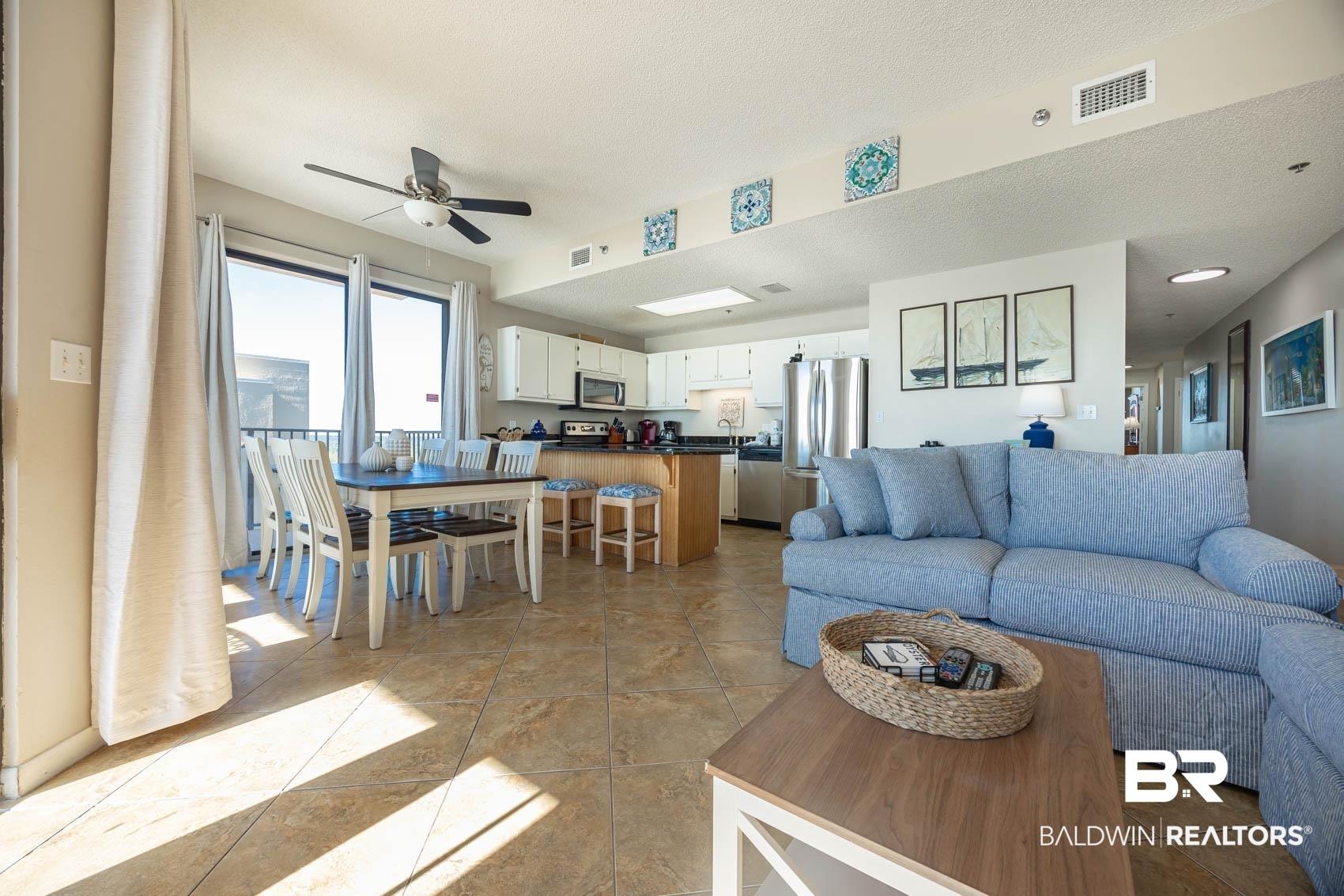 Image 4: Living area featuring ceiling fan and a textured ceiling