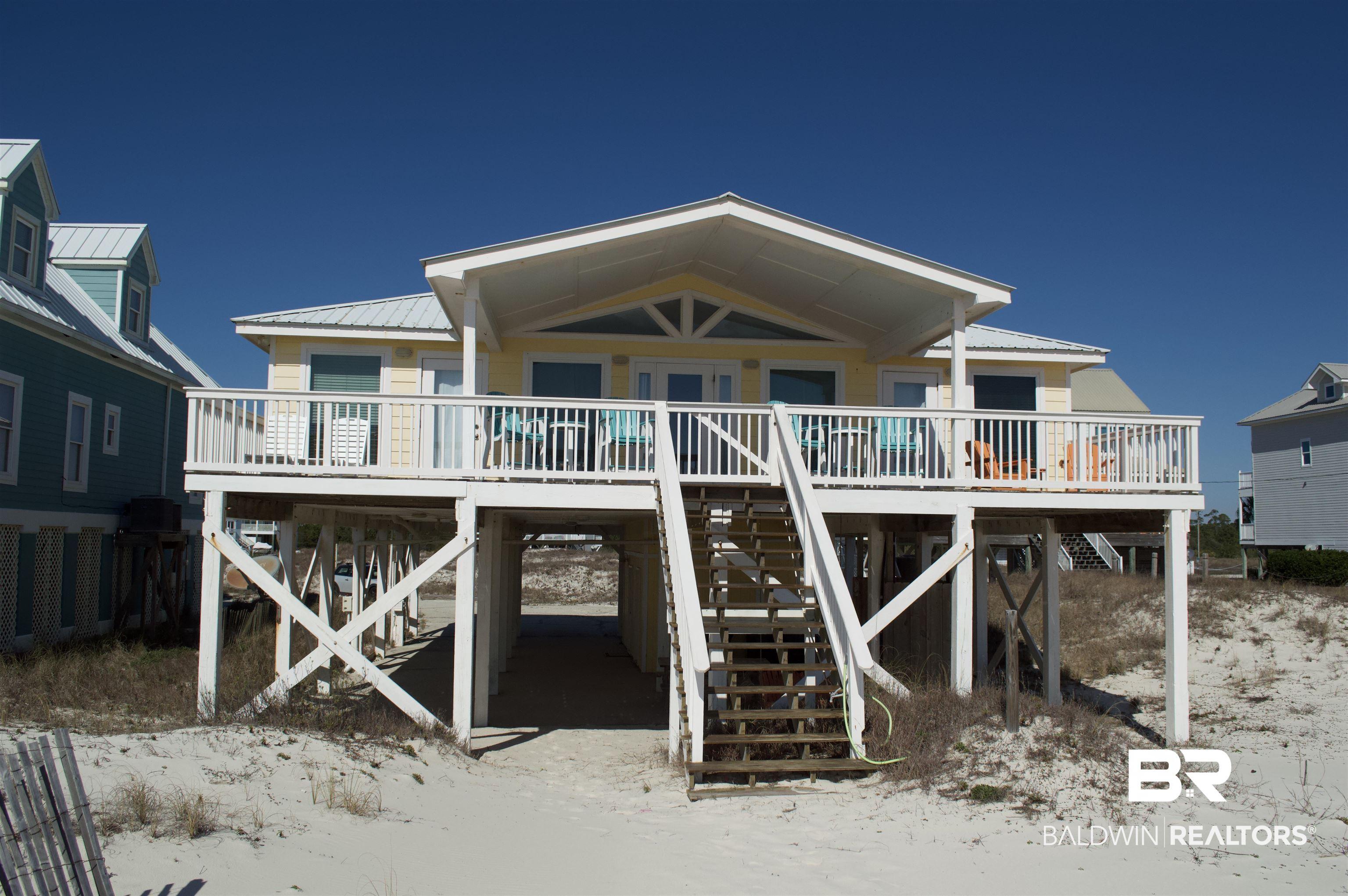 Image 2: Back of property with a metal roof and a wooden deck