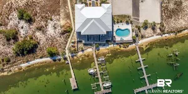 Image 4: Drone / aerial view of a pool area and a nearby body of water