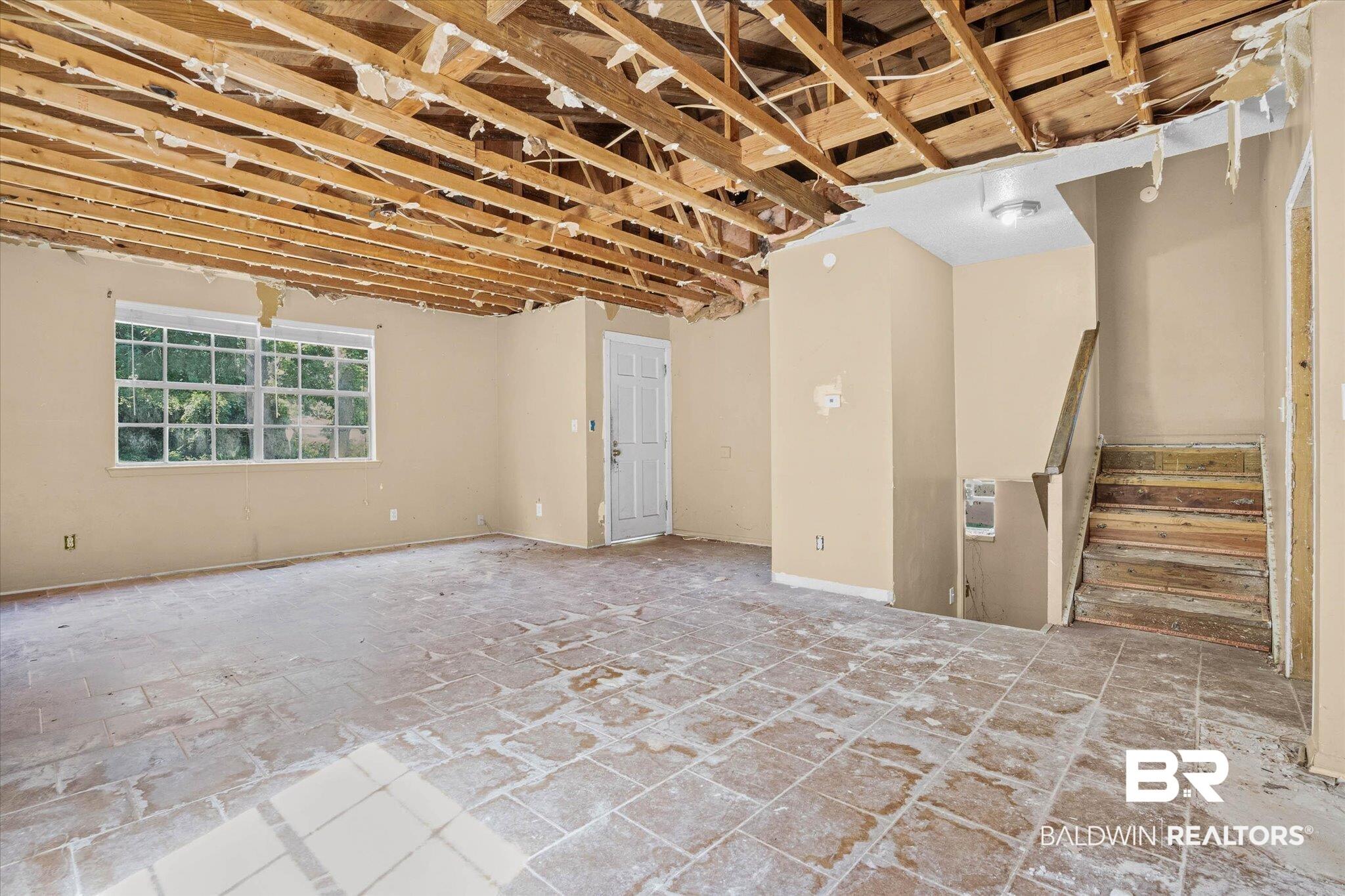 Image 4: Exposed ceiling joists provide an open framework for renovation