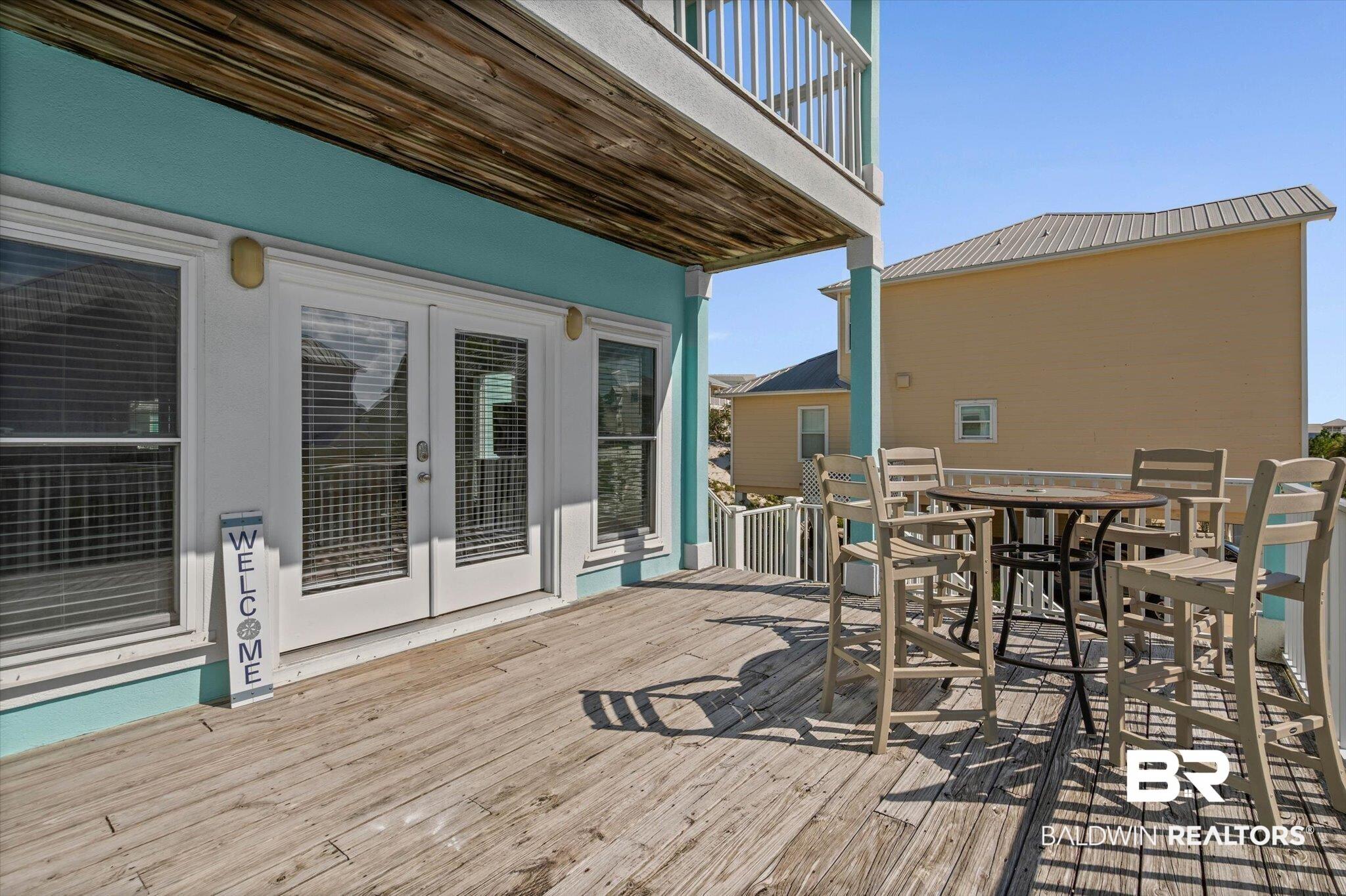 Image 2: Front Deck with french doors and outdoor dining space