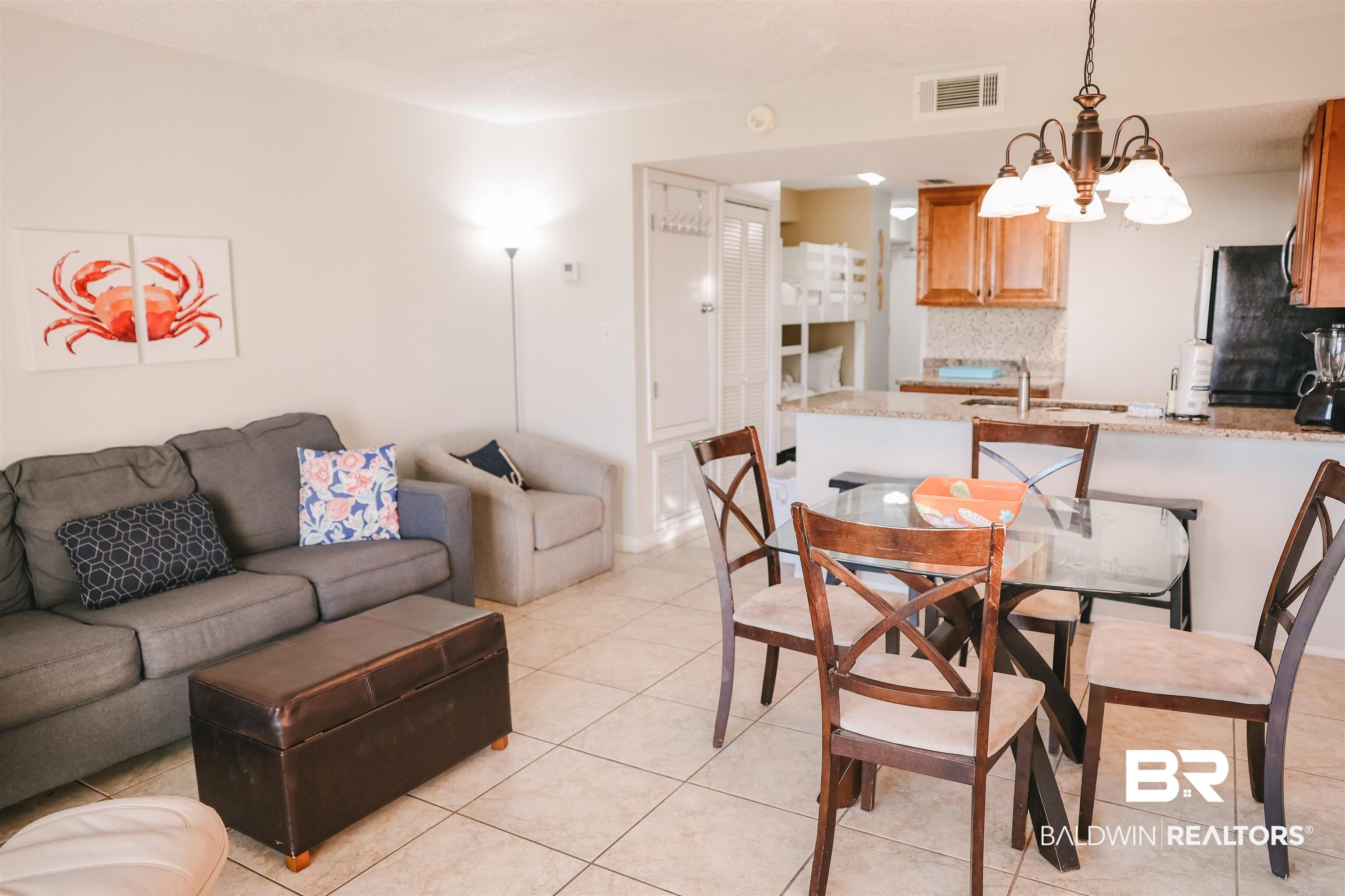 Image 3: Dining room featuring a chandelier and light tile patterned flooring