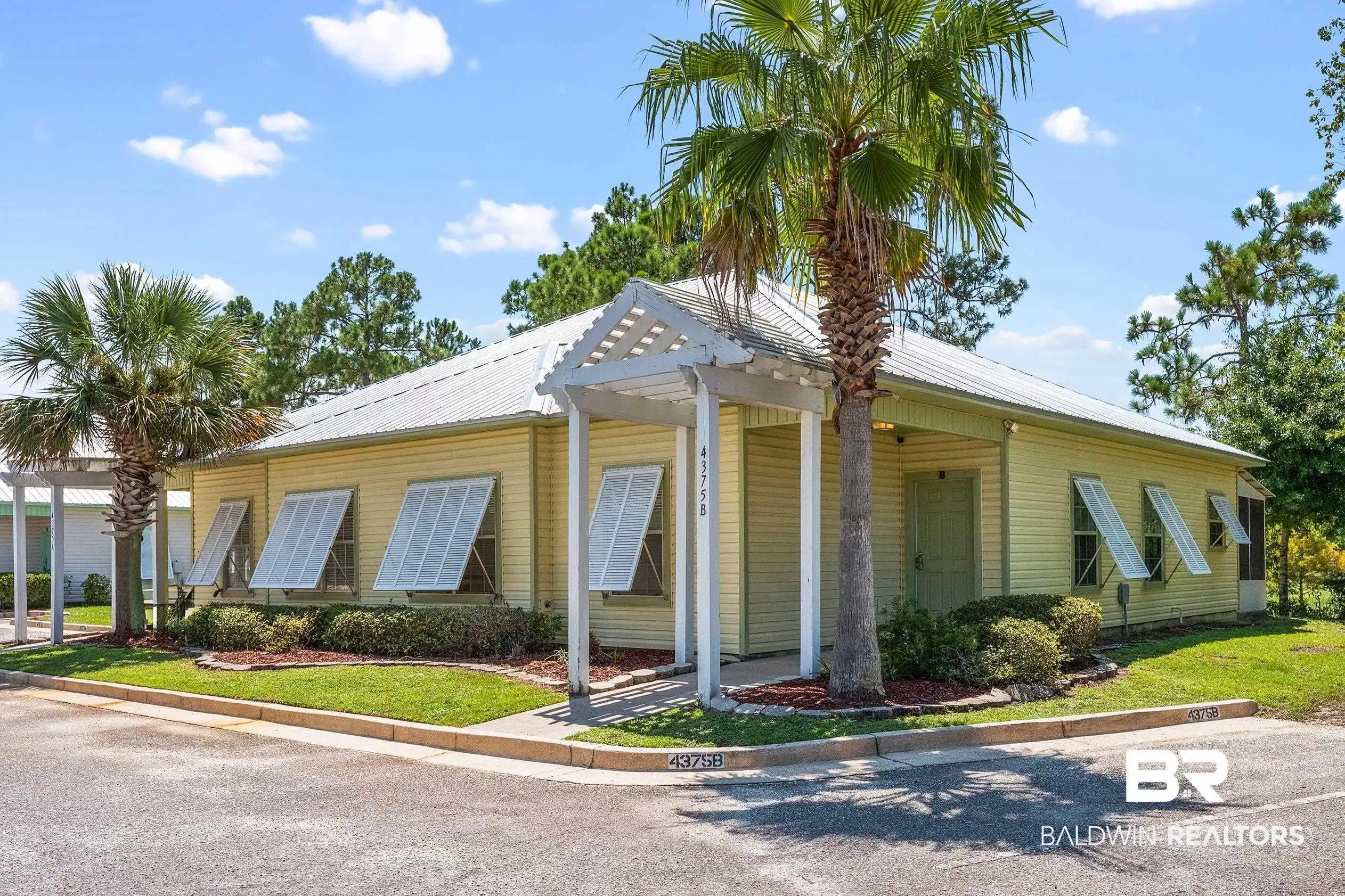 Image 1: Bungalow-style house featuring a metal roof