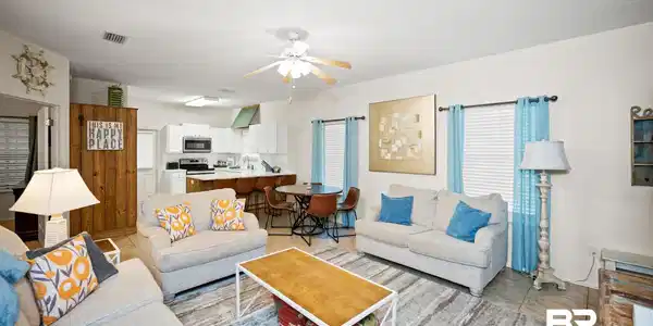 Image 3: Living area with light tile patterned flooring and ceiling fan