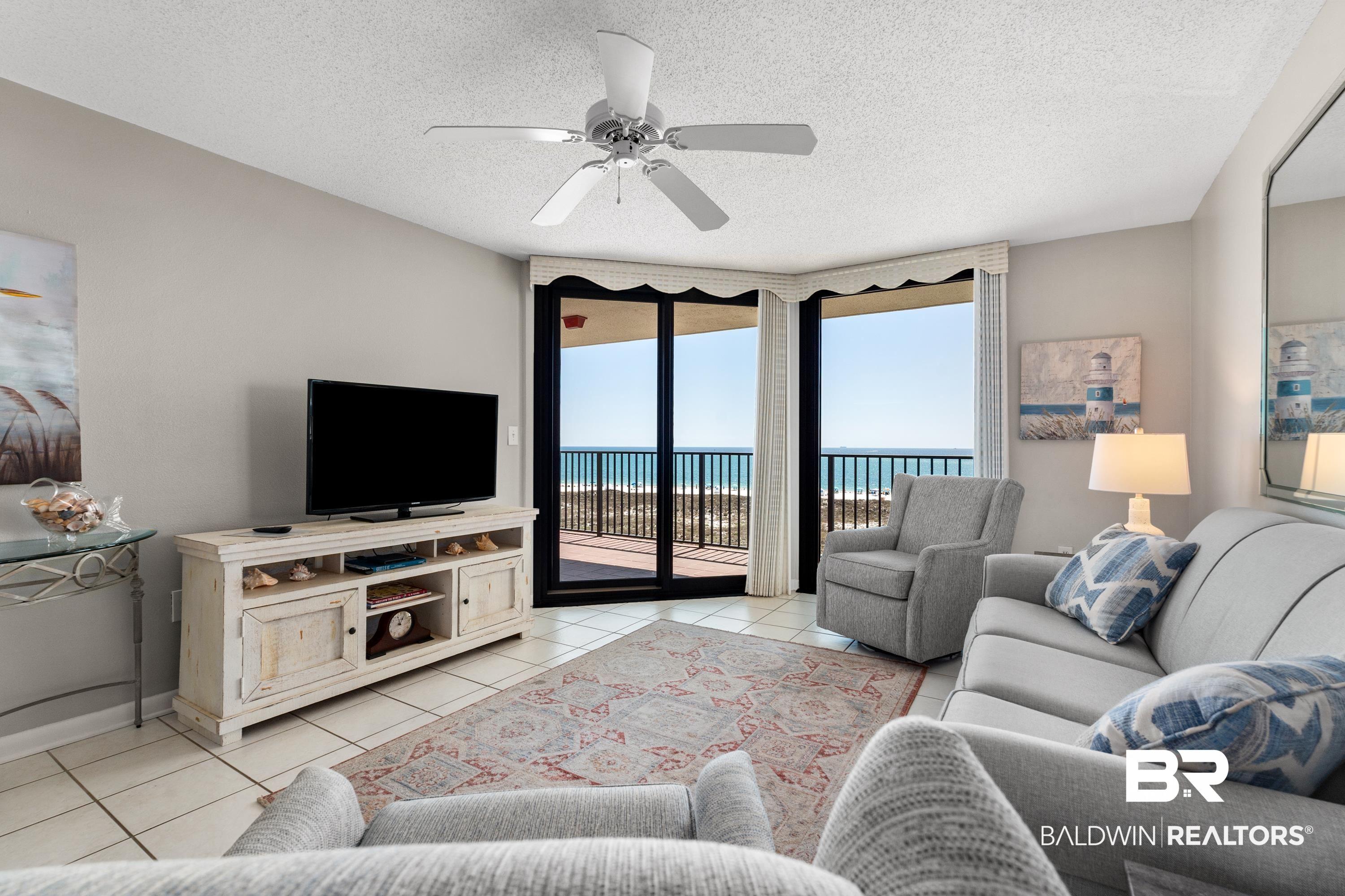 Image 3: Living room with a ceiling fan, a textured ceiling, and light tile patterned floors