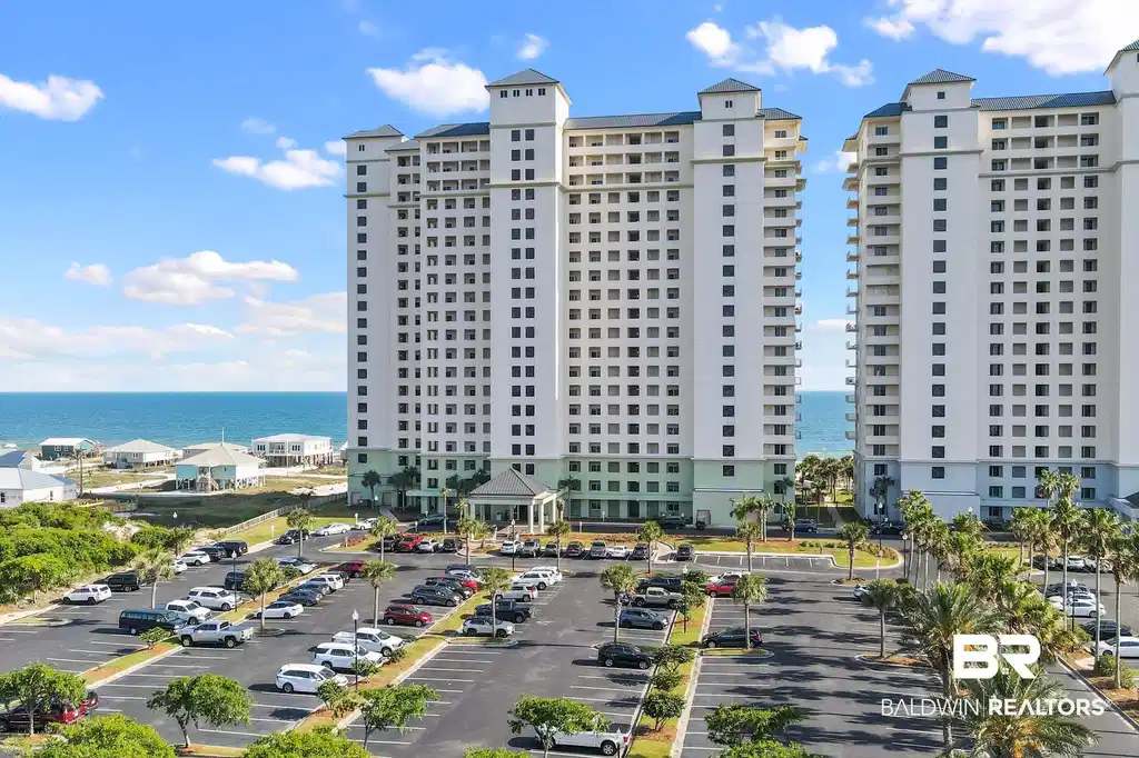 Image 1: View of property featuring a water view and uncovered parking