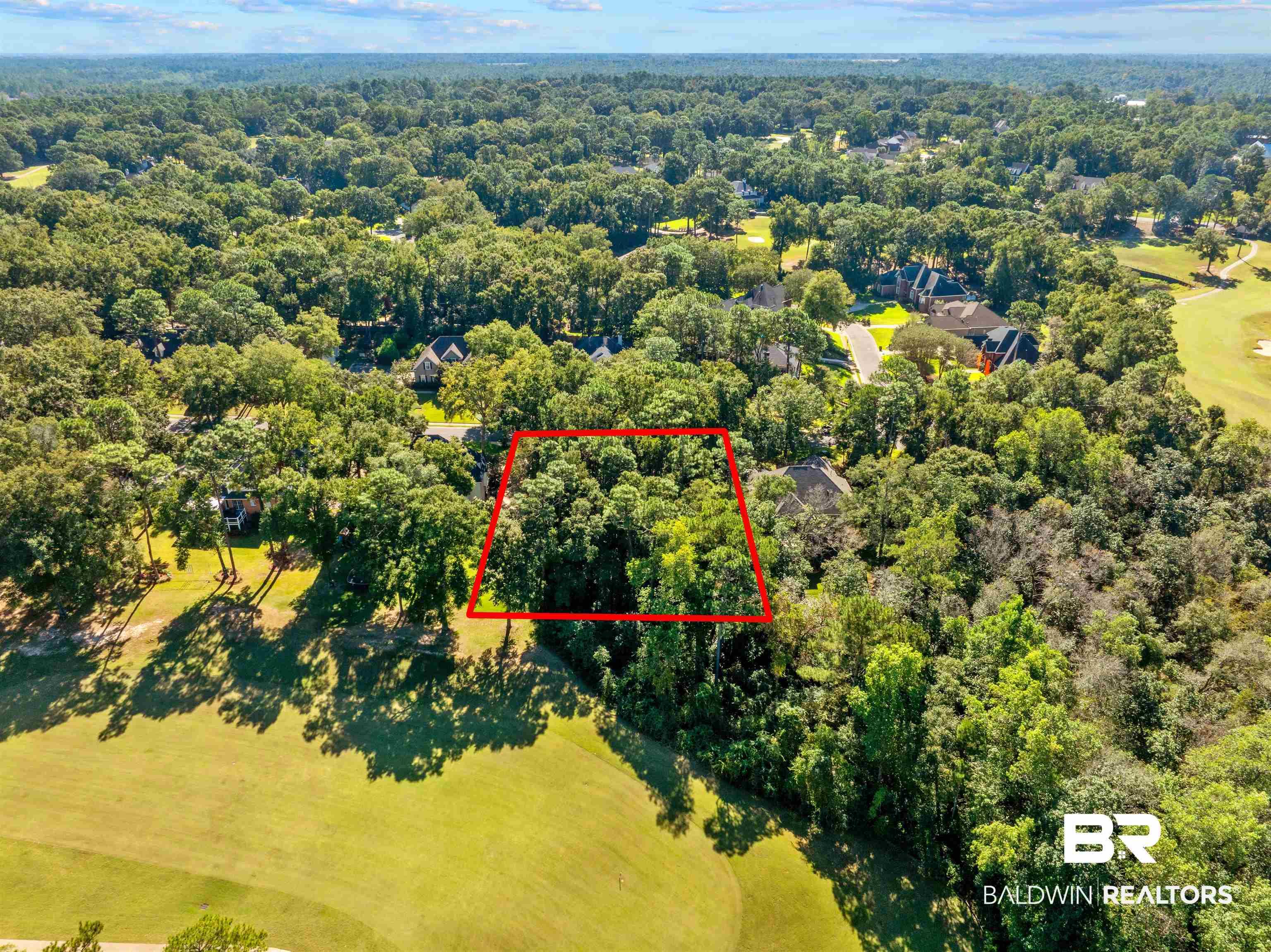 Image 3: Aerial overview of property's location featuring property boundaries highlighted and a heavily wooded area