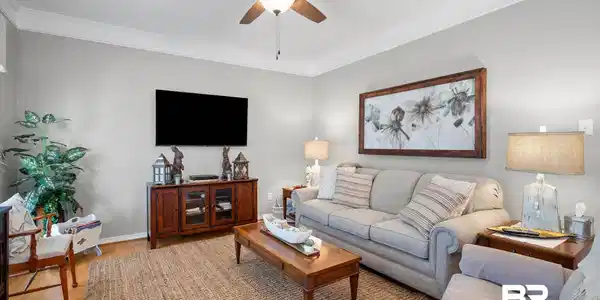 Image 3: Living area featuring ceiling fan, wood finished floors, and ornamental molding