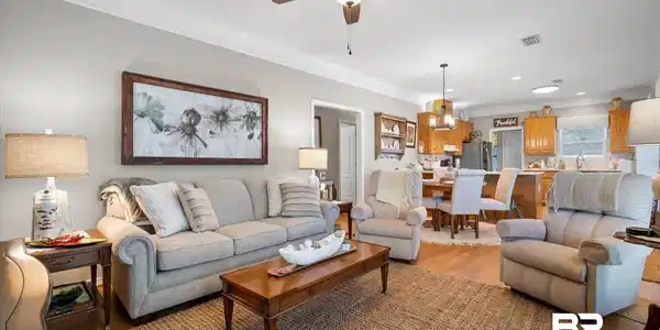 Image 4: Living area featuring crown molding, light wood-style flooring, and ceiling fan