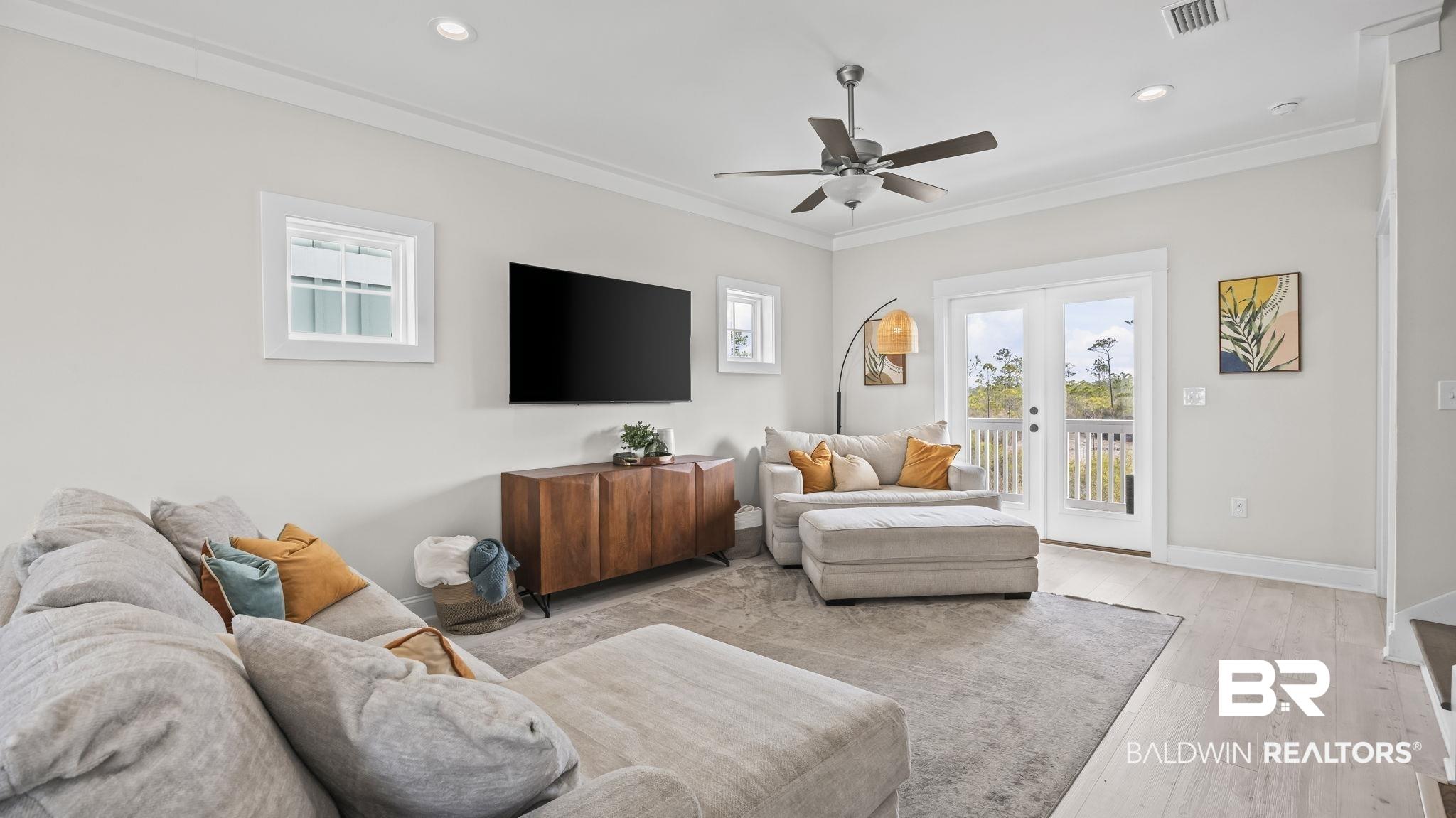 Image 3: Living area featuring ceiling fan, light wood-type flooring, crown molding, and recessed lighting