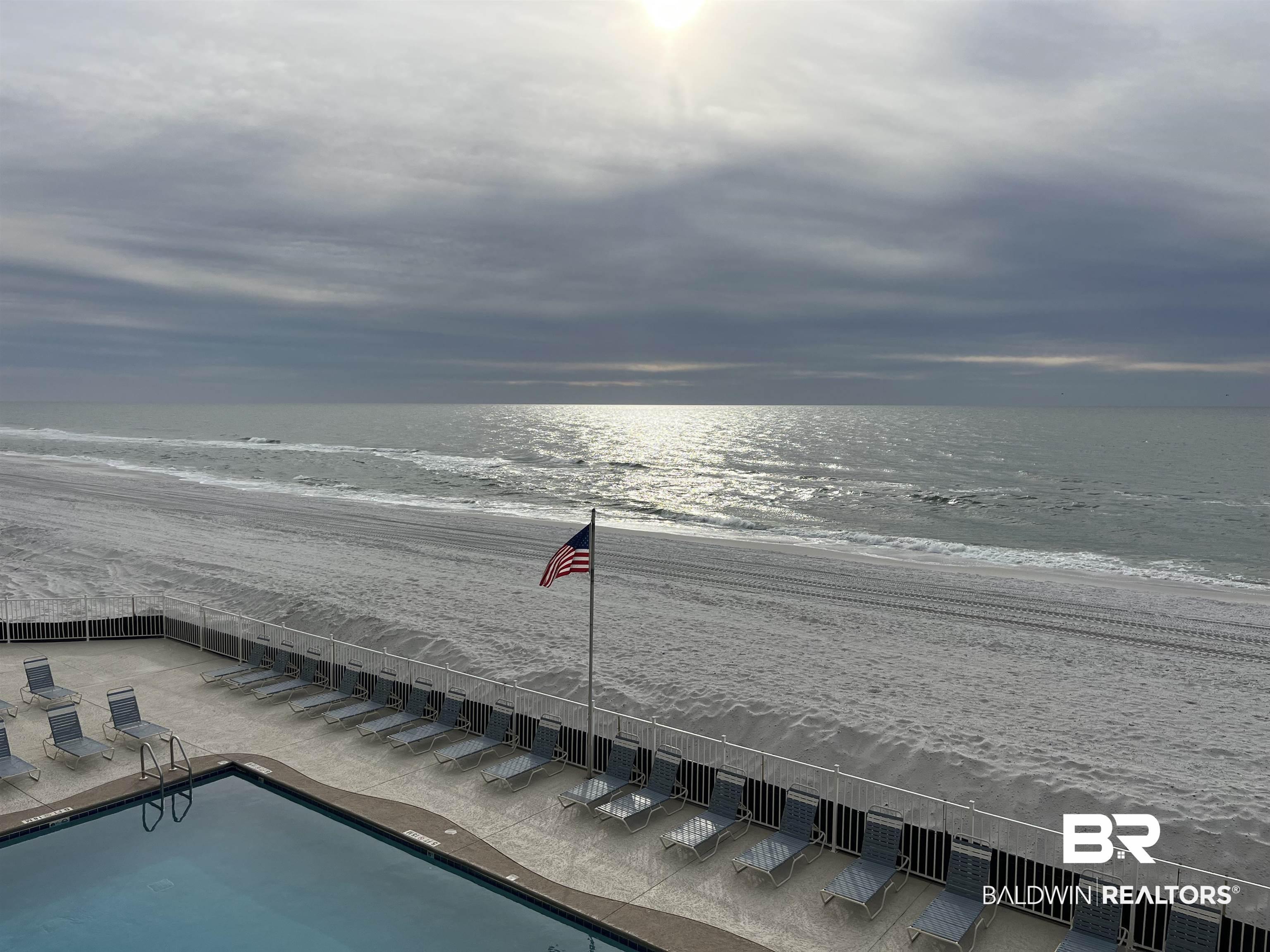 Image 2: Outdoor swimming pool with direct beach access