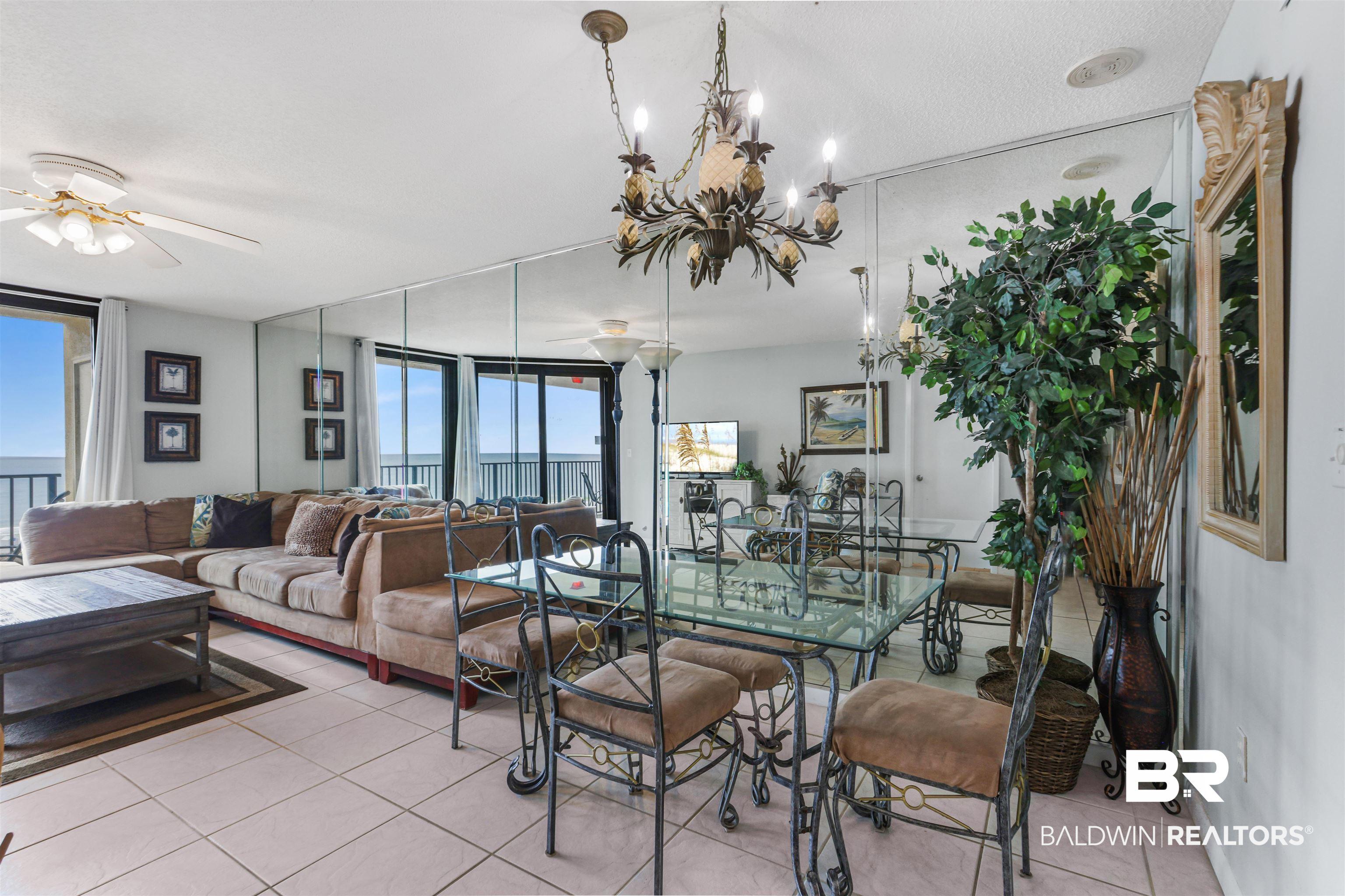 Image 3: Dining room featuring tile patterned flooring, a chandelier, and a ceiling fan