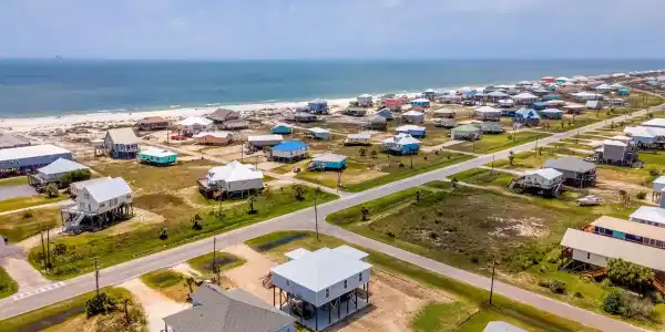 Image 3: Aerial view of residential area featuring a large body of water
