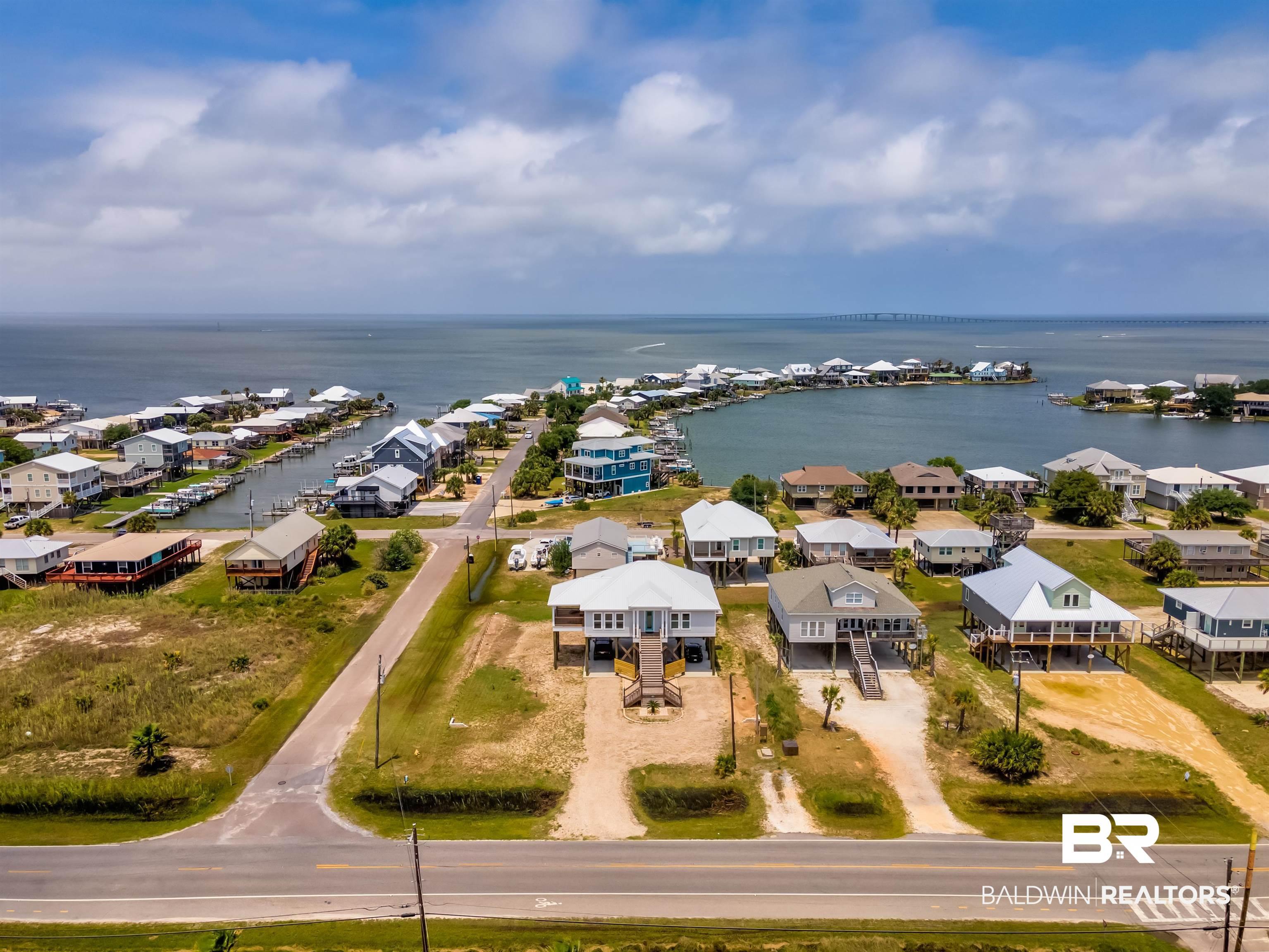 Image 4: Aerial view of residential area with a large body of water