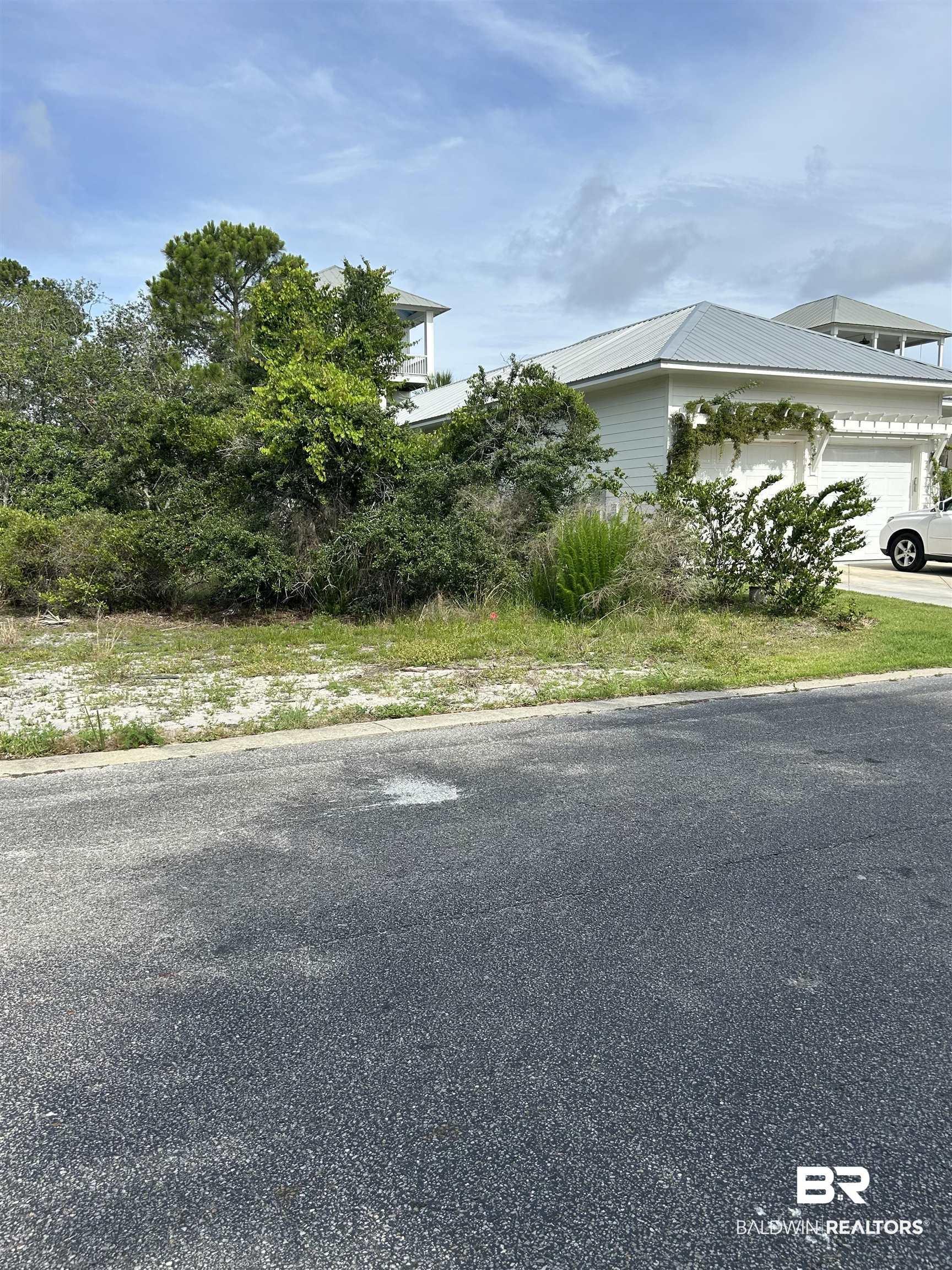 Image 3: View of side of home with a garage and metal roof