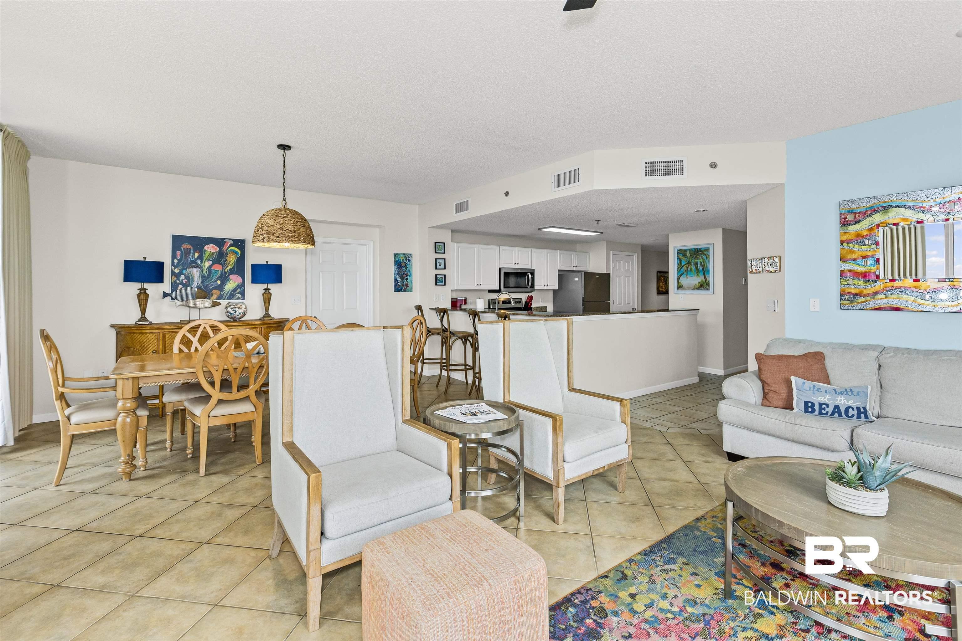 Image 4: Living area with light tile patterned floors
