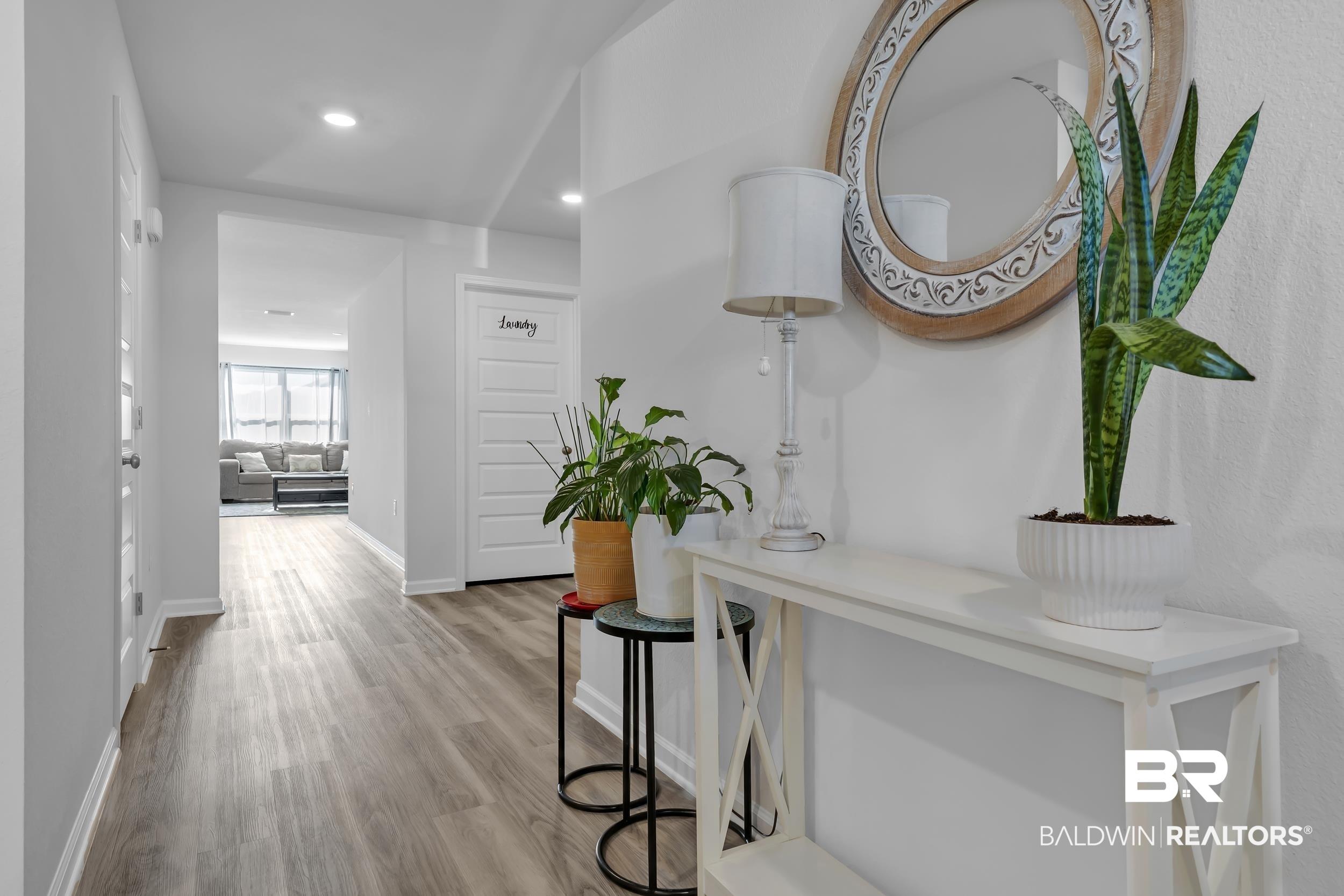 Image 3: Open hallway featuring wood-finish flooring, recessed lighting, and crisp white baseboards