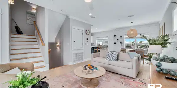 Image 4: Open-concept living space featuring wood-finish flooring, a contemporary ceiling fan, recessed lighting, and shiplap accent walls