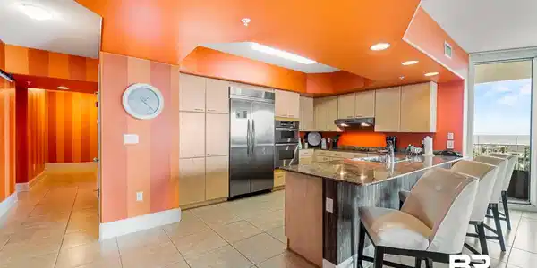 Image 4: Kitchen with dark stone counters, appliances with stainless steel finishes, a peninsula, a kitchen bar, and recessed lighting