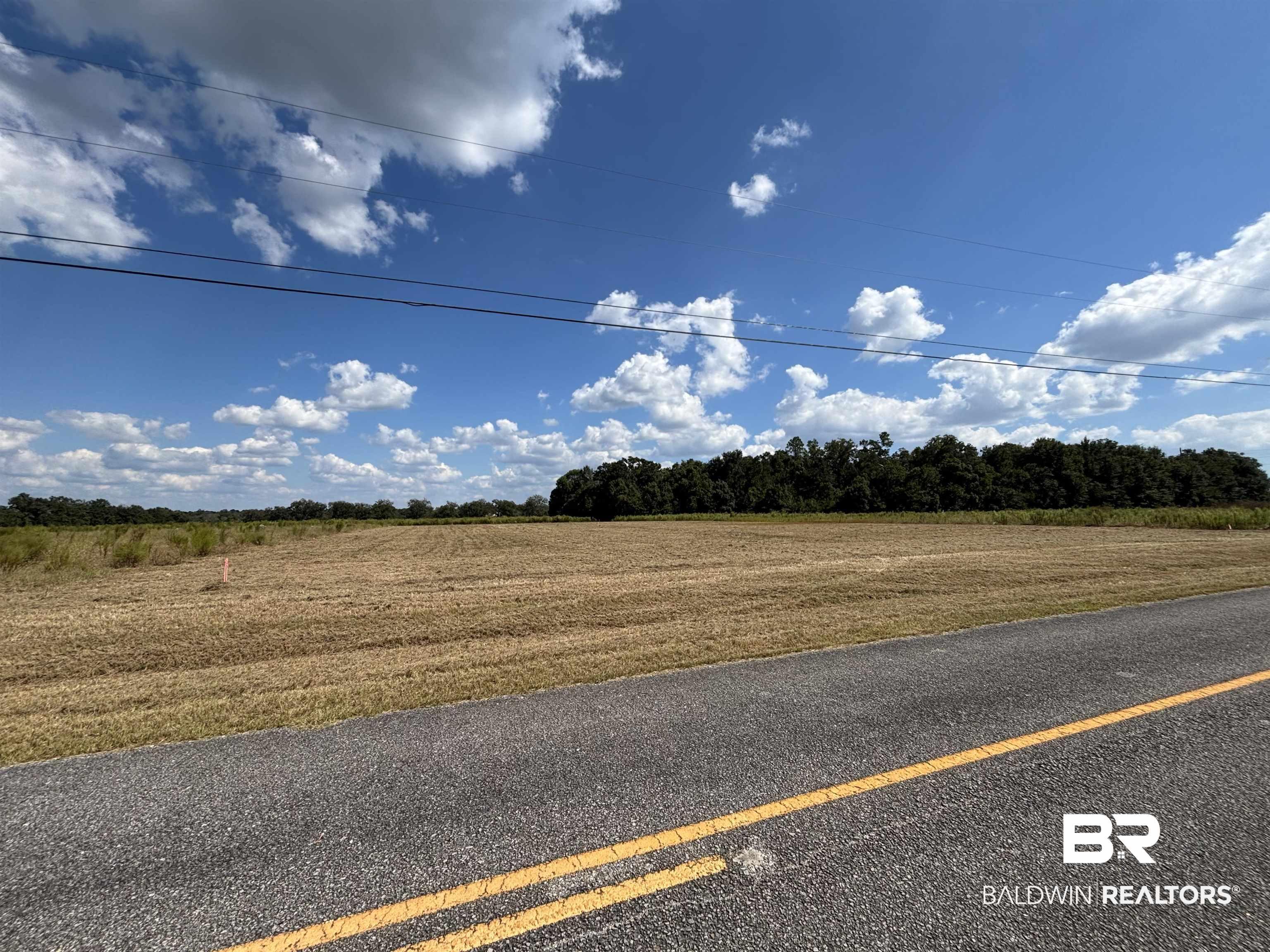 Image 1: View of asphalt street with a view of countryside