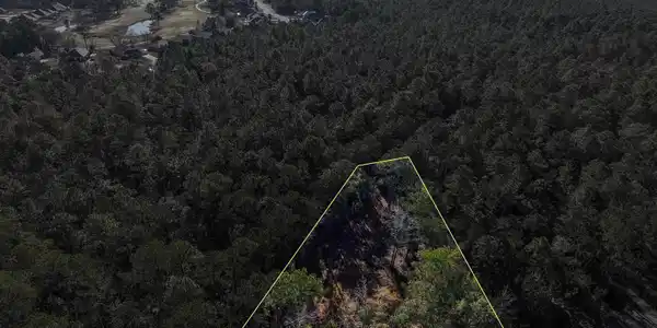 Image 3: View of urban area featuring property boundaries highlighted and a heavily wooded area