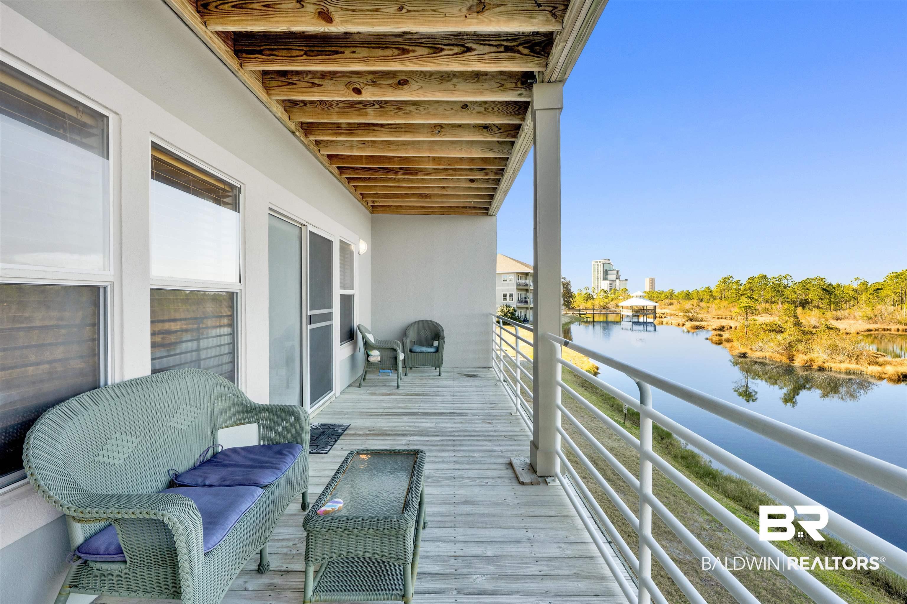 Image 3: Balcony featuring a water view