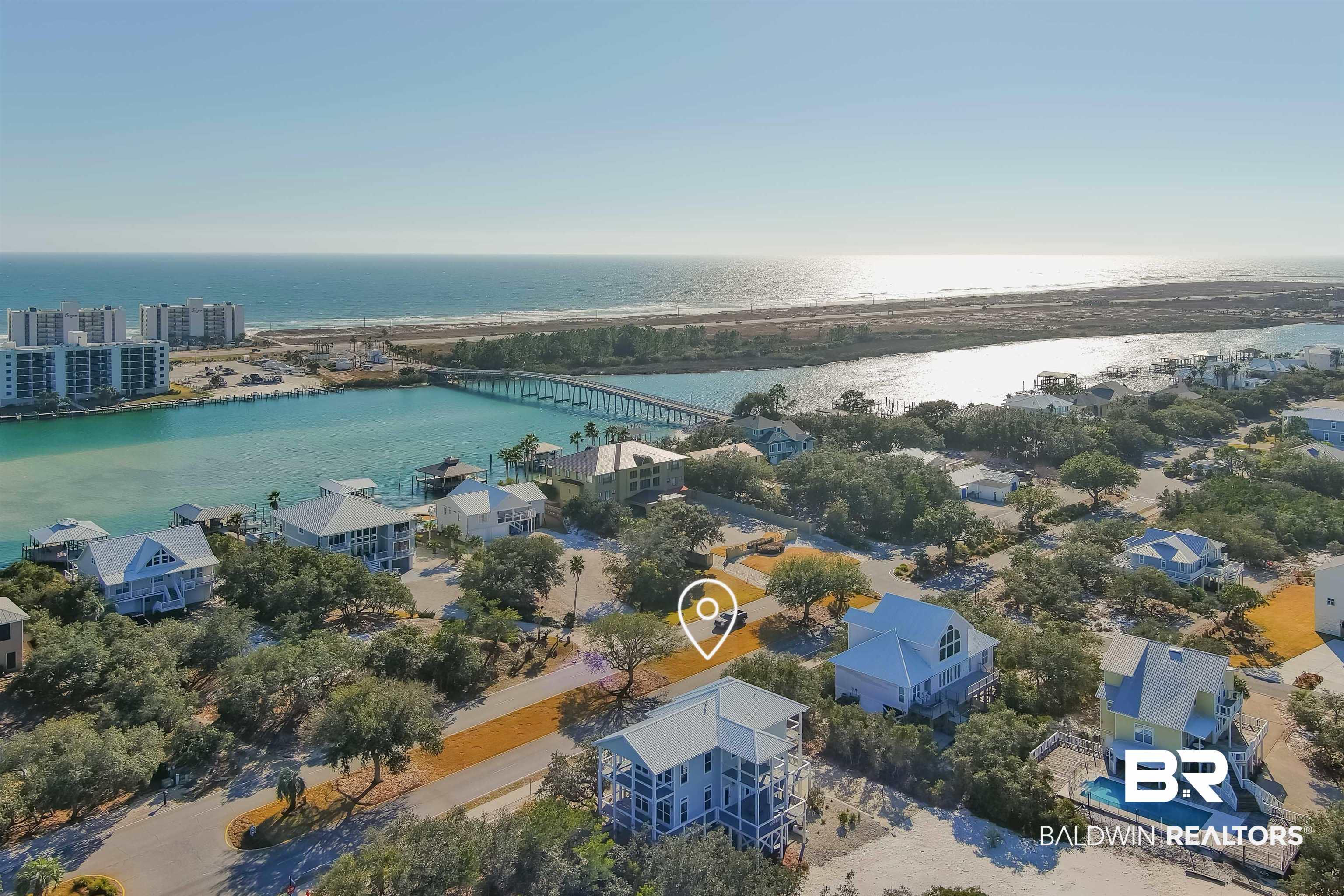 Image 2: Aerial view of residential area with a large body of water and a notable bridge