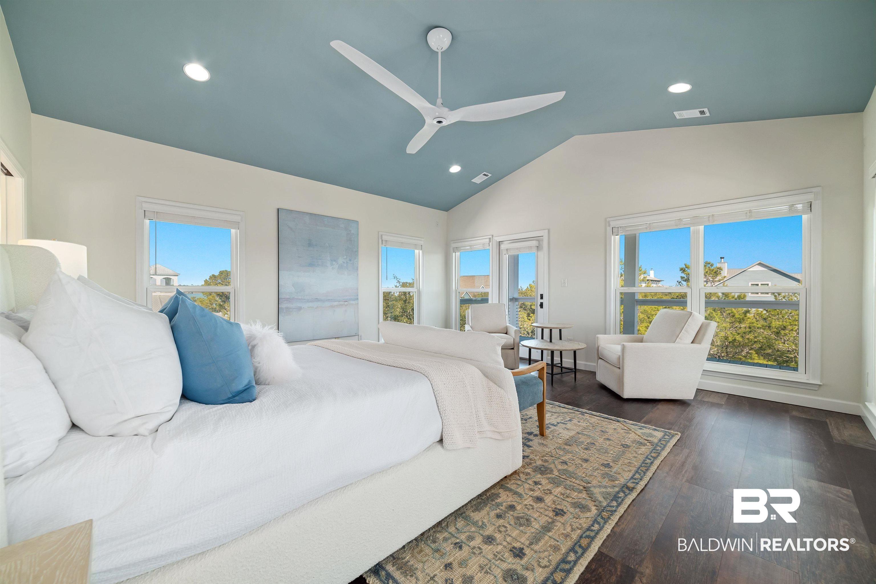 Image 3: Bedroom with dark wood finished floors, a ceiling fan, recessed lighting, vaulted ceiling, and access to outside