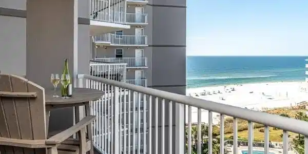 Image 2: Balcony with view of pool area and view of water and beach