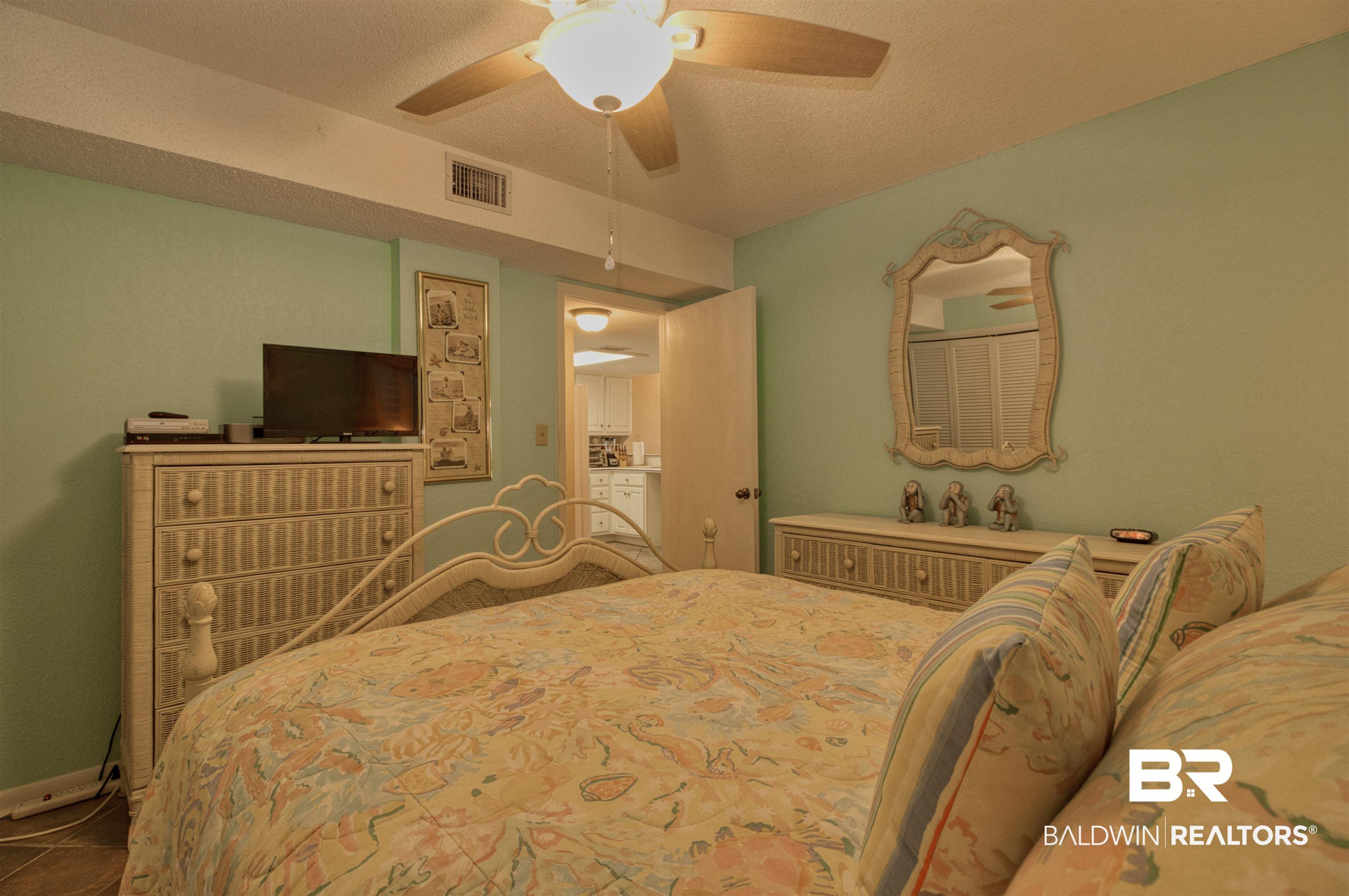 Image 4: Bedroom with ceiling fan and a textured ceiling