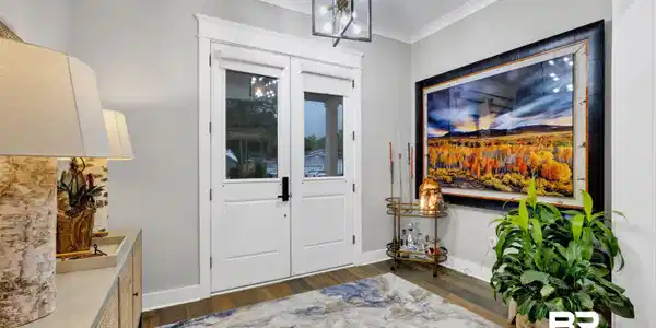 Image 4: Entryway featuring double French doors with transom, crown molding, wood-finish flooring, and a contemporary ceiling fixture
