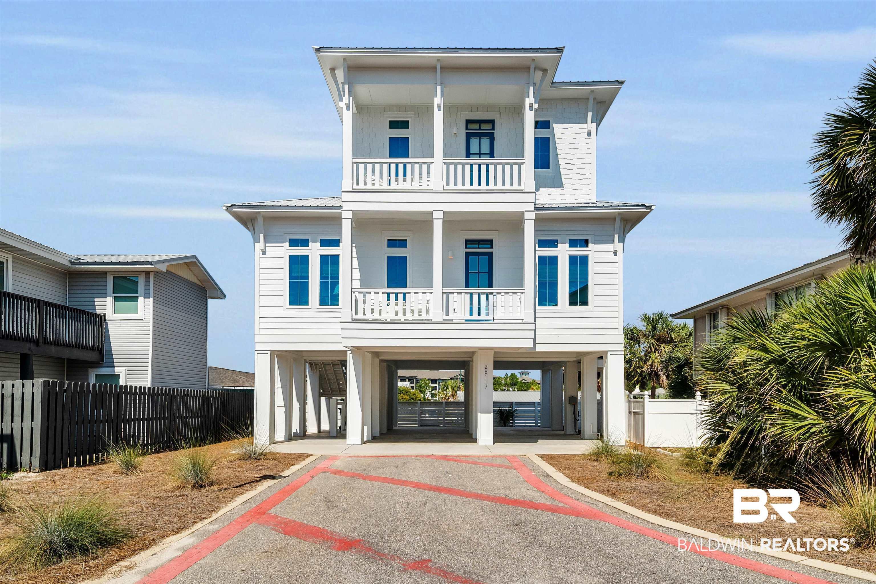 Image 1: View of front of property featuring a carport, driveway, and a metal roof