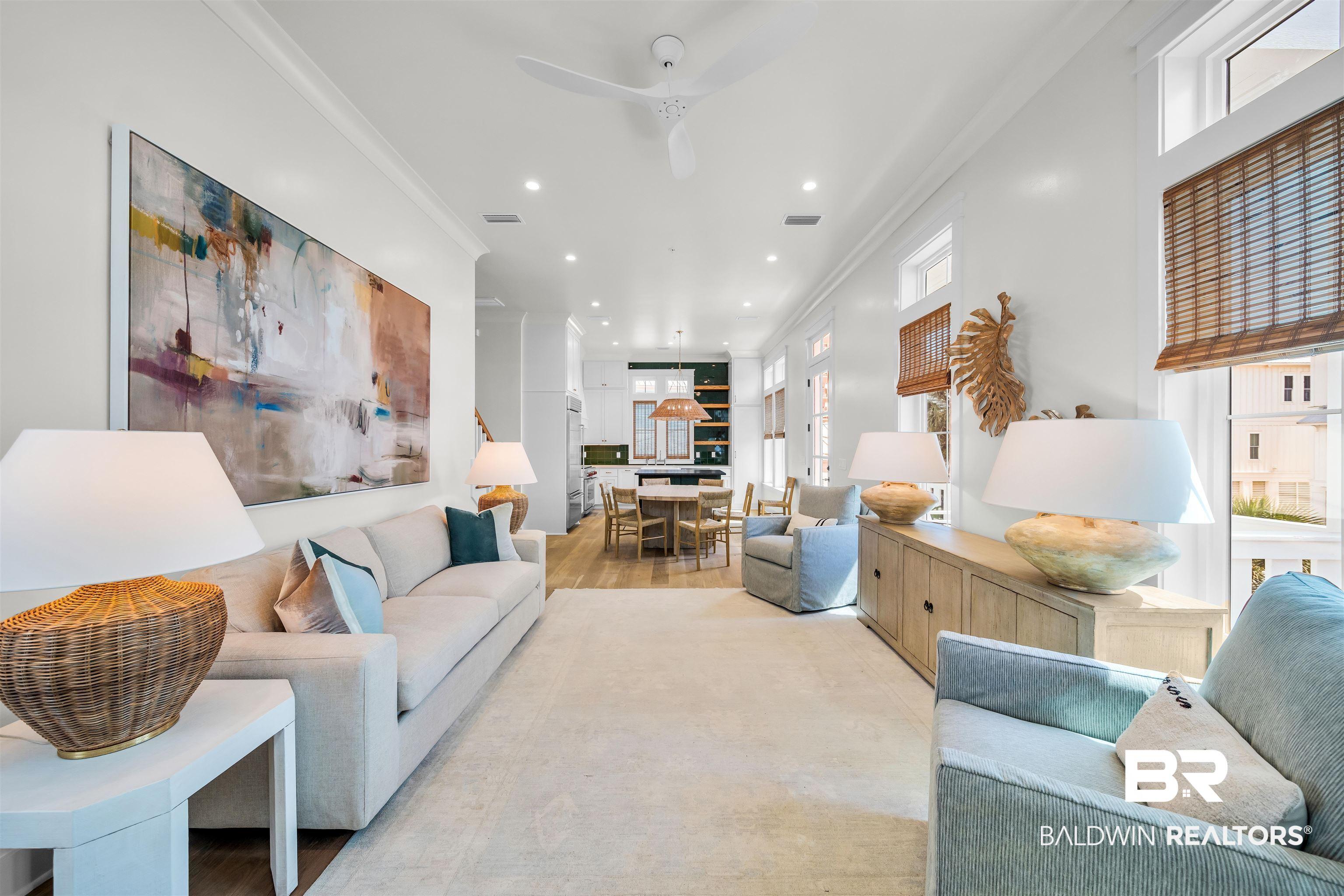 Image 4: Living area featuring healthy amount of natural light, crown molding, a ceiling fan, recessed lighting, and wood finished floors
