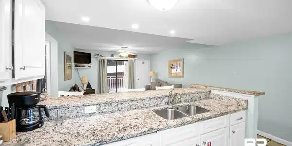 Image 3: Kitchen featuring white cabinetry, light stone counters, dishwasher, open floor plan, and recessed lighting